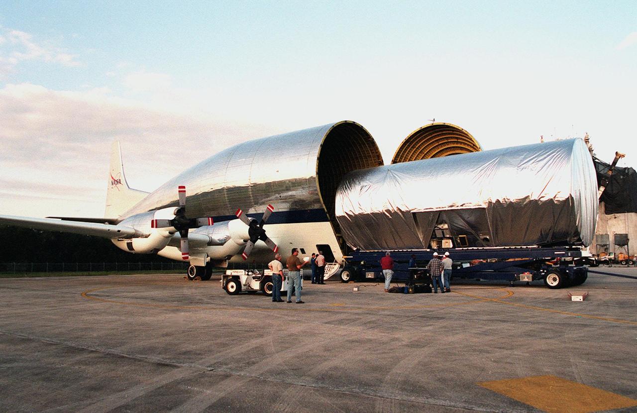 KENNEDY SPACE CENTER, FLA. -- Rolling out of NASA's Super Guppy aircraft aboard a payload transporter is a port-side P3 truss, a component for the International Space Station (ISS). The truss is scheduled to be added to the ISS on mission STS-115 in 2002 aboard Space Shuttle Atlantis. The second port truss segment, P3 will be attached to the first port truss segment (P1). The P3 truss will be taken to the Operations and Checkout Building.
