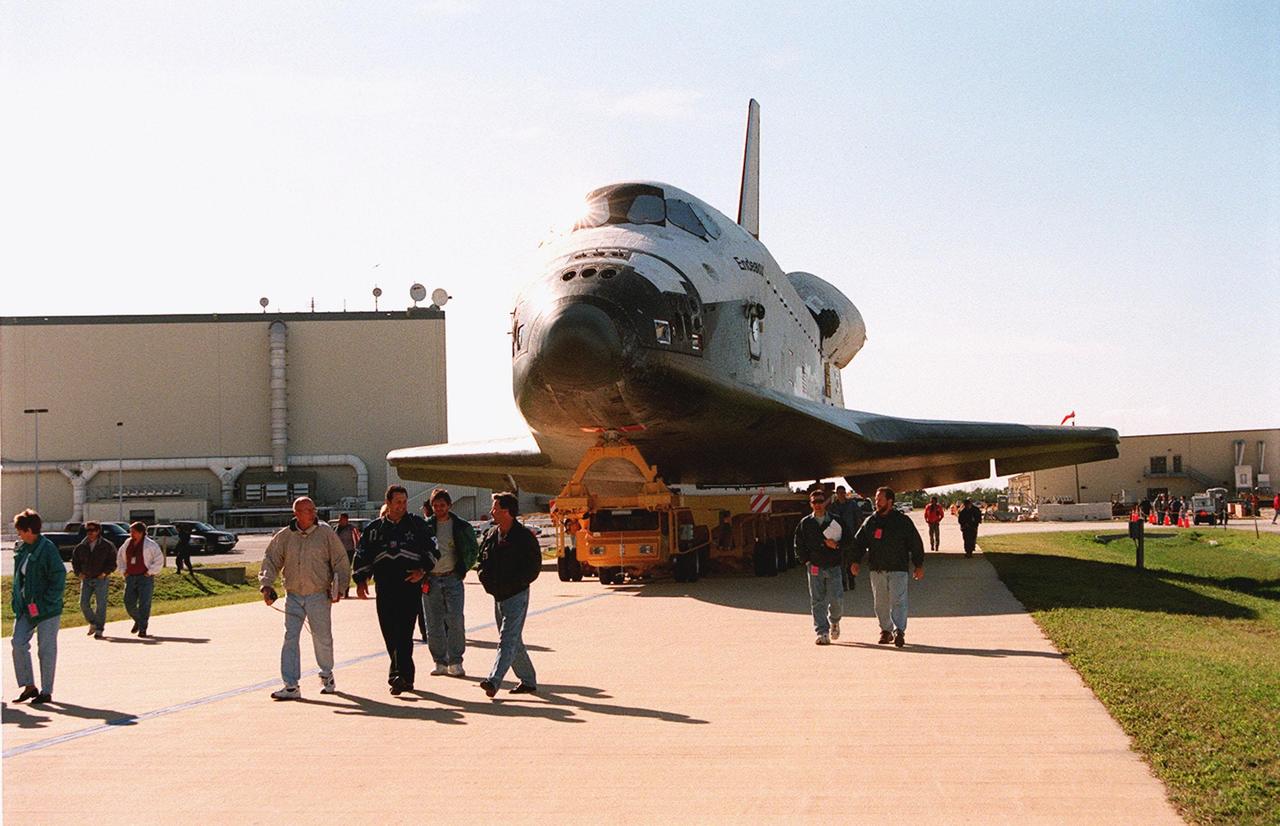 KENNEDY SPACE CENTER, FLA. -- Workers at KSC lead the way as Orbiter Endeavour, on an orbiter transfer vehicle, rolls from the Orbiter Processing Facility to the Vehicle Assembly Building, where it will be mated to the external tank and solid rocket boosters in high bay 1. Space Shuttle Endeavour is targeted for launch on mission STS-99 Jan. 13, 2000 at 1:11 p.m. EST. STS-99 is the Shuttle Radar Topography Mission, an international project spearheaded by the National Imagery and Mapping Agency and NASA, with participation of the German Aerospace Center DLR. The SRTM consists of a specially modified radar system that will gather data for the most accurate and complete topographic map of the Earth's surface that has ever been assembled. SRTM will make use of radar interferometry, wherein two radar images are taken from slightly different locations. Differences between these images allow for the calculation of surface elevation, or change. The SRTM hardware will consist of one radar antenna in the shuttle payload bay and a second radar antenna attached to the end of a mast extended 60 meters (195 feet) out from the shuttle