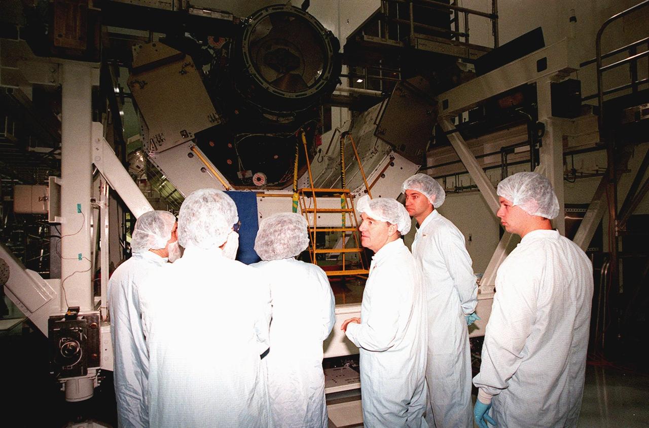 KENNEDY SPACE CENTER, FLA. -- In the Space Station Processing Facility, STS-102's Expedition II discuss the Pressurized Mating Adapter (PMA-3) (top of photo) with workers from Johnson Space Center. From left are Yuriy Vladimirovich Usachev, Dave Moore (JSC), Susan J. Helms, James S. Voss, Arne Aamodt and Matt Myers (both of JSC). The PMA-3 is a component of the International Space Station (ISS). Voss, Helms and Usachev will be staying on the ISS, replacing the Expedition I crew, Bill Shepherd, Sergei Krikalev and Yuri Gidzenko. Along with the crew, Mission STS-102 also will be carrying the Leonardo Multi-Purpose Logistics Module (MPLM) to the ISS. The Leonardo will be filled with equipment and supplies to outfit the U.S. laboratory module, which will have been carried to the ISS on a preceding Shuttle flight. In order to function as an attached station module as well as a cargo transport, logistics modules (there are three) also include components that provide some life support, fire detection and suppression, electrical distribution and computer functions. Eventually, the modules also will carry refrigerator freezers for transporting experiment samples and food to and from the station. STS-102 is scheduled to launch no earlier than Oct. 19, 2000, from Launch Pad 39A, Kennedy Space Center