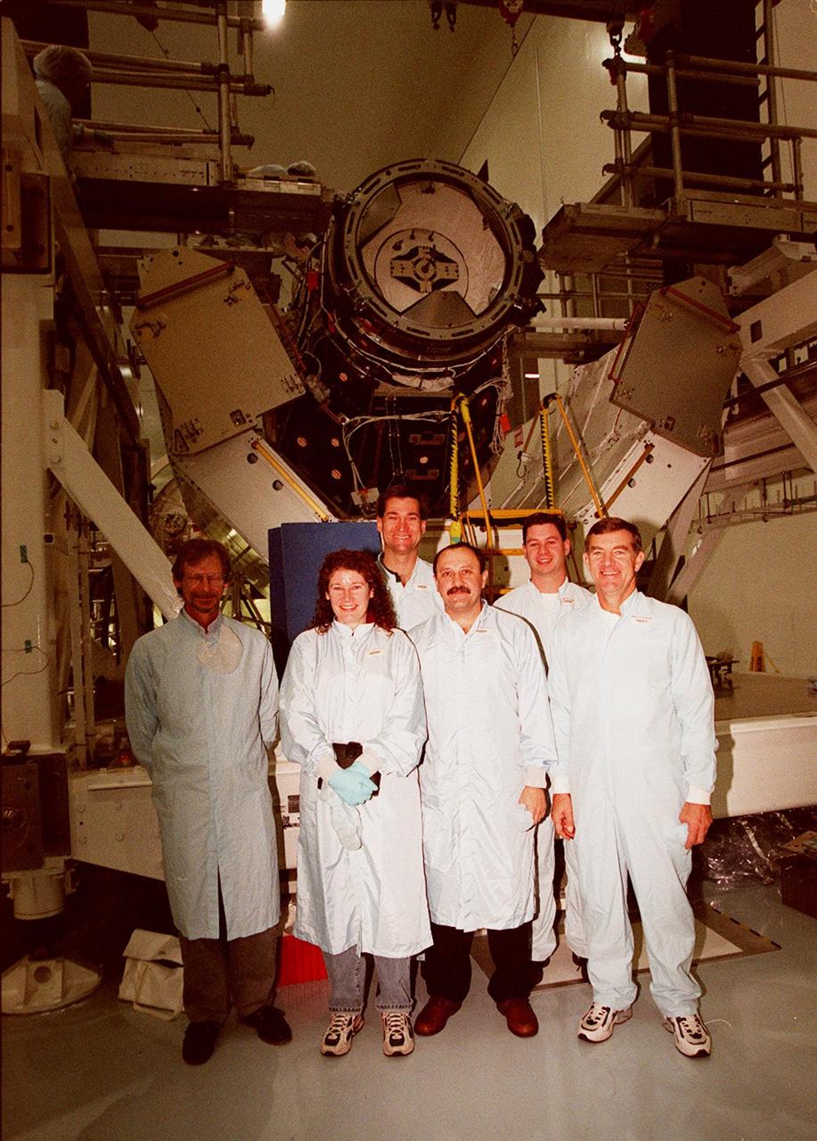 KENNEDY SPACE CENTER, FLA. -- In the Space Station Processing Facility, members of the STS-102 crew pose with workers from Johnson Space Center in front of the Pressurized Mating Adapter (PMA-3), a component of the International Space Station (ISS). From left are Dave Moore (JSC), Susan J. Helms, Arne Aamodt (JSC), Yuriy Vladimirovich Usachev, Matt Myers (JSC) and James S. Voss. Voss, Helms and Usachev, known as the Expedition II crew, will be staying on the ISS, replacing the Expedition I crew, Bill Shepherd, Sergei Krikalev and Yuri Gidzenko. Along with the crew, Mission STS-102 also will be carrying the Leonardo Multi-Purpose Logistics Module (MPLM) to the ISS. The Leonardo will be filled with equipment and supplies to outfit the U.S. laboratory module, which will have been carried to the ISS on a preceding Shuttle flight. In order to function as an attached station module as well as a cargo transport, logistics modules (there are three) also include components that provide some life support, fire detection and suppression, electrical distribution and computer functions. Eventually, the modules also will carry refrigerator freezers for transporting experiment samples and food to and from the station. STS-102 is scheduled to launch no earlier than Oct. 19, 2000, from Launch Pad 39A, Kennedy Space Center
