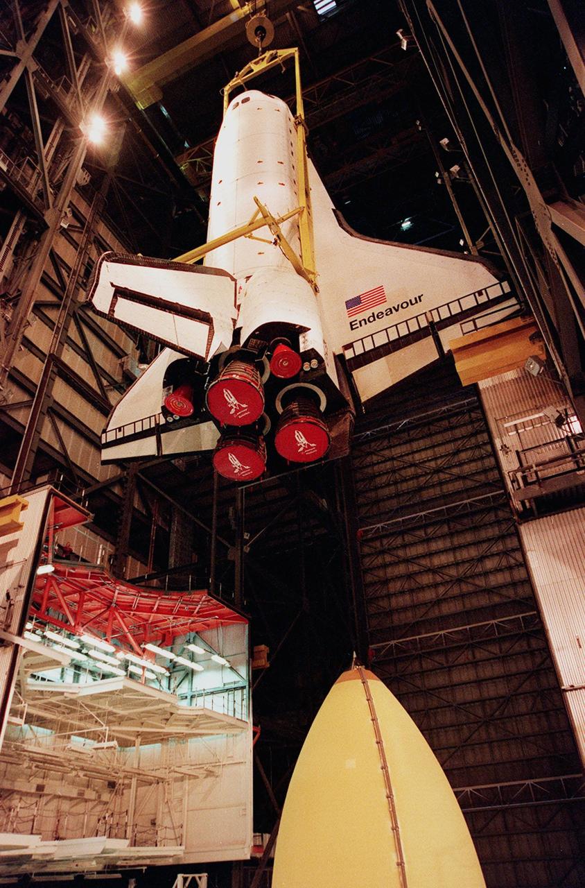 KENNEDY SPACE CENTER, FLA. -- Inside the VAB, orbiter Endeavour is lifted to a vertical position before being mated to the external tank (bottom of photo) and solid rocket boosters in high bay 1. Space Shuttle Endeavour is targeted for launch on mission STS-99 Jan. 13, 2000, at 1:11 p.m. EST. STS-99 is the Shuttle Radar Topography Mission, an international project spearheaded by the National Imagery and Mapping Agency and NASA, with participation of the German Aerospace Center DLR. The SRTM consists of a specially modified radar system that will gather data for the most accurate and complete topographic map of the Earth's surface that has ever been assembled. SRTM will make use of radar interferometry, wherein two radar images are taken from slightly different locations. Differences between these images allow for the calculation of surface elevation, or change. The SRTM hardware will consist of one radar antenna in the shuttle payload bay and a second radar antenna attached to the end of a mast extended 60 meters (195 feet) out from the shuttle