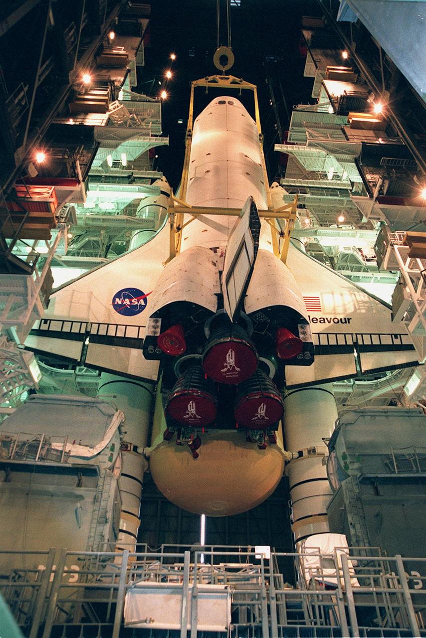 KENNEDY SPACE CENTER, FLA. -- Lights frame the orbiter Endeavour as it is lowered onto the platform for mating with the external tank and solid rocket boosters. Space Shuttle Endeavour is targeted for launch on mission STS-99 Jan. 13, 2000, at 1:11 p.m. EST. STS-99 is the Shuttle Radar Topography Mission, an international project spearheaded by the National Imagery and Mapping Agency and NASA, with participation of the German Aerospace Center DLR. The SRTM consists of a specially modified radar system that will gather data for the most accurate and complete topographic map of the Earth's surface that has ever been assembled. SRTM will make use of radar interferometry, wherein two radar images are taken from slightly different locations. Differences between these images allow for the calculation of surface elevation, or change. The SRTM hardware will consist of one radar antenna in the shuttle payload bay and a second radar antenna attached to the end of a mast extended 60 meters (195 feet) out from the shuttle