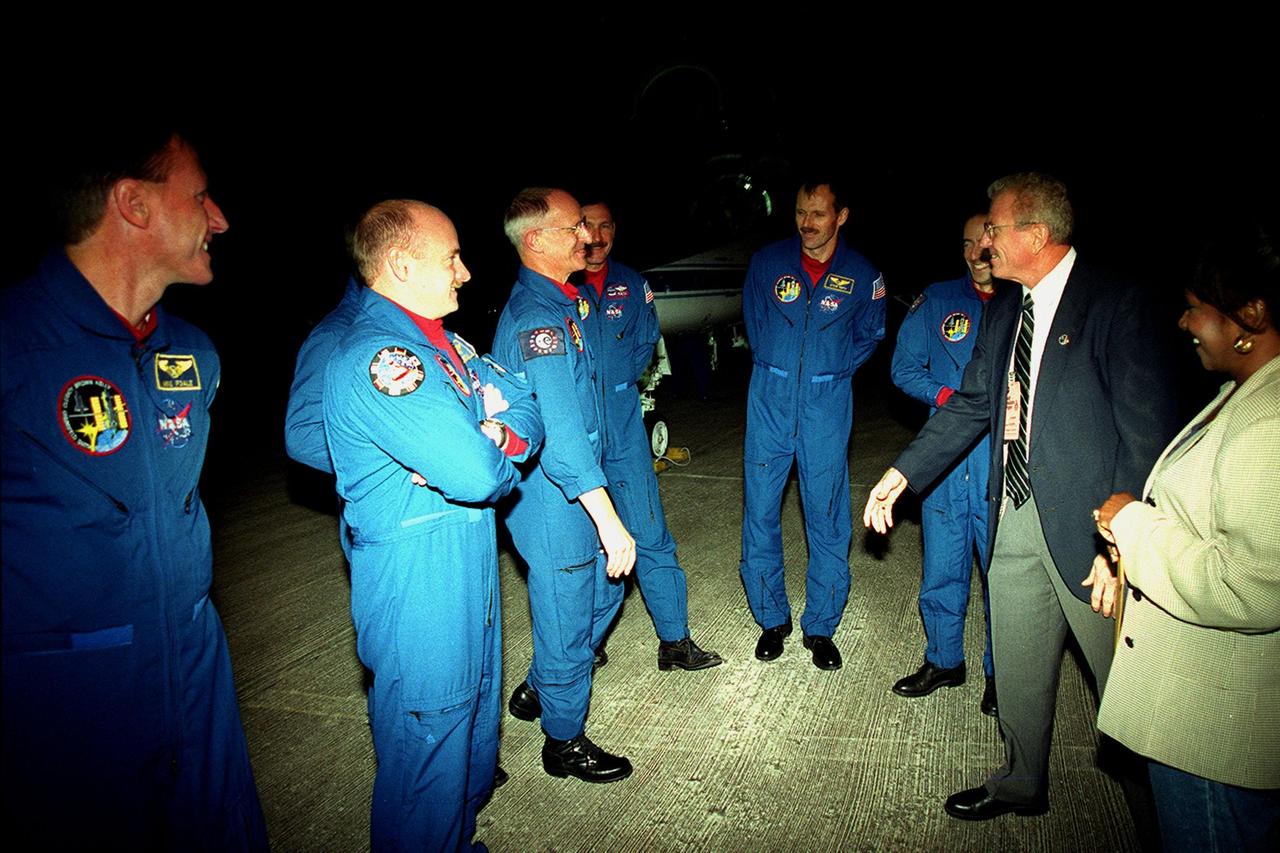 At the Shuttle Landing Facility, the STS-103 crew is greeted by Loren Shriver, Deputy Director for Launch and Payload Processing, upon their arrival aboard T-38 jets to make final preparations for launch. From left are Mission Specialist C. Michael Foale (Ph.D.), Pilot Scott J. Kelly, Mission Specialist John M. Grunsfeld (Ph.D.) (hidden behind Kelly), Mission Specialist Claude Nicollier of Switzerland, Commander Curtis L. Brown Jr., Mission Specialist Steven L. Smith, Mission Specialist Jean-François Clervoy of France, Loren Shriver, and Delores Green with KSC's Astronaut Office. Nicollier and Clervoy are with the European Space Agency. Shriver was the commander of the STS-31 crew which originally deployed the telescope in April of 1990. The STS-103 mission, to service the Hubble Space Telescope a third time, is scheduled for launch Dec. 11 at 12:13 a.m. EST from Launch Pad 39B