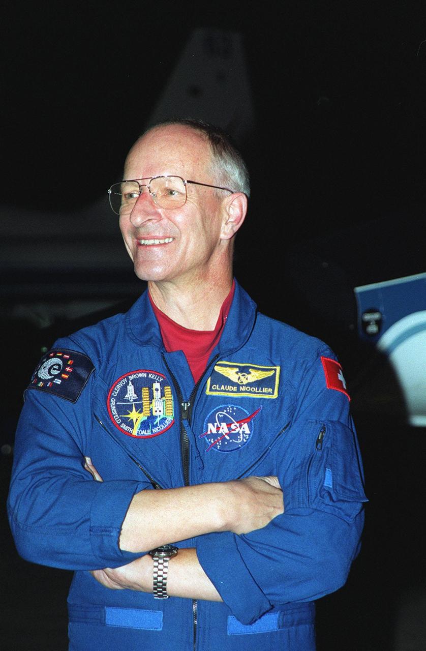 At the Shuttle Landing Facility, STS-103 Mission Specialist Claude Nicollier of Switzerland shows his pleasure at being at Kennedy Space Center to make final preparations for his launch. He is accompanied by the other STS-103 crew members: Commander Curtis L. Brown Jr., Pilot Scott J. Kelly and Mission Specialists Steven L. Smith, C. Michael Foale (Ph.D.), John M. Grunsfeld (Ph.D.), and Jean-François Clervoy of France. Nicollier and Clervoy both represent the European Space Agency. The STS-103 mission, to service the Hubble Space Telescope a third time, is scheduled for launch Dec. 11 at 12:13 a.m. EST from Launch Pad 39B