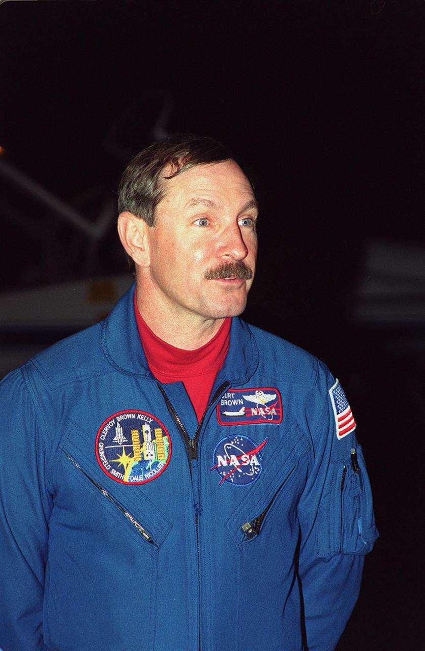 Commander Curtis L. Brown Jr. smiles on his arrival at the Shuttle Landing Facility aboard a T-38 jet aircraft. He joins other crew members Pilot Scott J. Kelly and Mission Specialists Steven L. Smith, C. Michael Foale (Ph.D.), John M. Grunsfeld (Ph.D.), Claude Nicollier of Switzerland and Jean-François Clervoy of France, for pre-launch preparations on mission STS-103 aboard Space Shuttle Discovery. Nicollier and Clervoy are with the European Space Agency. The mission, to service the Hubble Space Telescope, is scheduled for launch Dec. 11 at 12:13 a.m. EST from Launch Pad 39B. Discovery is expected to land at KSC Monday, Dec. 20, at 9:21 p.m. EST