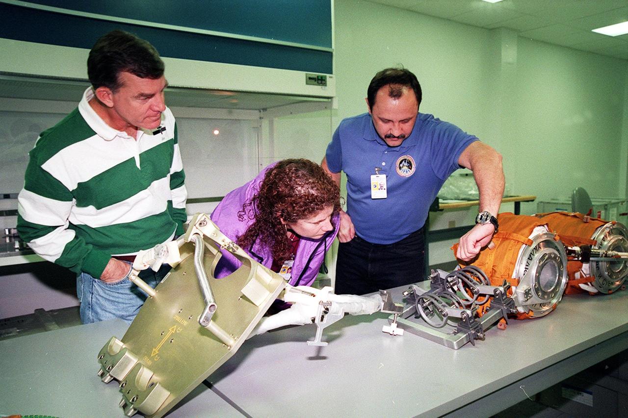 KENNEDY SPACE CENTER, FLA. -- At SPACEHAB, in Titusville, Fla., members of the STS-102 crew look at part of the cargo for their mission. From left are Mission Specialists James Voss, Susan Helms and Yuri Usachev, with the Russian Space Agency (RSA). STS-102 is a resupply mission to the International Space Station, transporting the Leonardo Multi-Purpose Logistics Module (MPLM) with equipment to assist in outfitting the U.S. Lab, which will already be in place. The mission is also transporting Helms, Voss and Usachev as the second resident crew (designated Expedition crew 2) to the station. In exchange, the mission will return to Earth the first expedition crew on ISS: William Shepherd, Sergei Krikalev (RSA) and Yuri Gidzenko (RSA). STS-102 is scheduled to launch no earlier than Oct. 19, 2000
