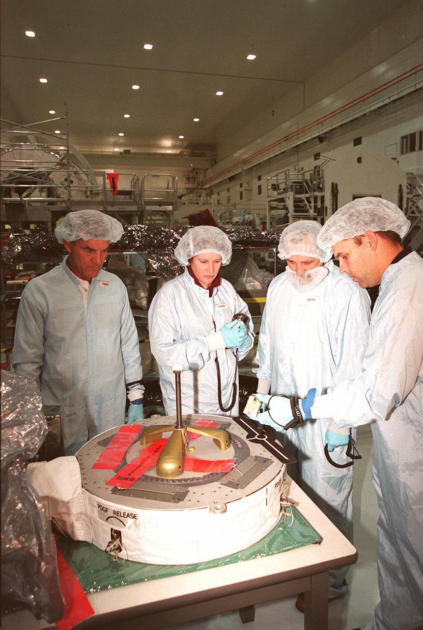 Inside the Space Station Processing Facility (SSPF), a technician (right) explains use of the equipment in front of (left) STS-102 Mission Specialists James Voss, Susan Helms and Yuri Usachev, with the Russian Space Agency (RSA). STS-102 is a resupply mission to the International Space Station, transporting the Leonardo Multi-Purpose Logistics Module (MPLM) with equipment to assist in outfitting the U.S. Lab, which will already be in place. The mission is also transporting Helms, Voss and Usachev as the second resident crew (designated Expedition crew 2) to the station. In exchange, the mission will return to Earth the first expedition crew on ISS: William Shepherd, Sergei Krikalev (RSA) and Yuri Gidzenko (RSA). STS-102 is scheduled to launch no earlier than Oct. 19, 2000