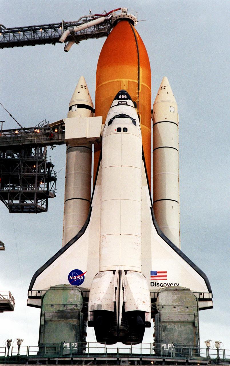 As dawn breaks at Launch Pad 39B on the east coast of Florida, the Space Shuttle Discovery is revealed after rollback of the Rotating Service Structure. The rollback of the structure was complete at 4:46 a.m. EST. Poised for flight on mission STS-103, Discovery is scheduled for launch Dec. 16 at 9:18 p.m. EST. The mission is expected to last about 9 days and 21 hours with a landing at KSC Sunday, Dec. 26, at 6:56 p.m. EST