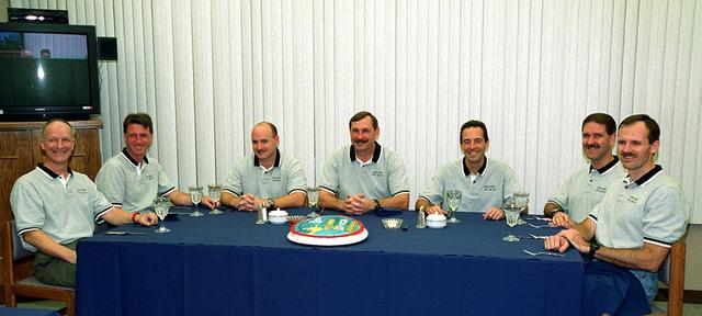 In the Operations and Checkout Building, the STS-103 crew are all smiles as they gather for breakfast before suiting up for launch. From left are Mission Specialists Claude Nicollier of Switzerland and C. Michael Foale (Ph.D.), Pilot Scott J. Kelly, Commander Curtis L. Brown Jr., and Mission Specialists Jean-Francois Clervoy of France, John M. Grunsfeld (Ph.D.) and Steven L. Smith. Nicollier and Clervoy are with the European Space Agency. The STS-103 mission, to service the Hubble Space Telescope, is scheduled for launch Dec. 17 at 8:47 p.m. EST from Launch Pad 39B. Mission objectives include replacing gyroscopes and an old computer, installing another solid state recorder, and replacing damaged insulation in the telescope. The mission is expected to last about 8 days and 21 hours. Discovery is expected to land at KSC Sunday, Dec. 26, at about 6:30 p.m. EST