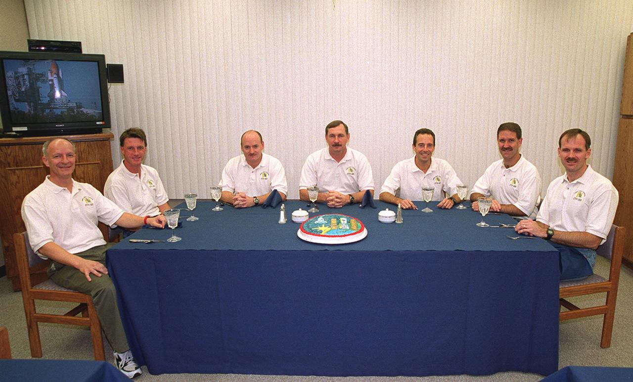 For the second time in two days, the STS-103 crew have breakfast before suiting up for launch. From left are Mission Specialists Claude Nicollier of Switzerland and C. Michael Foale (Ph.D.), Pilot Scott J. Kelly, Commander Curtis L. Brown Jr., and Mission Specialists Jean-Francois Clervoy of France, John M. Grunsfeld (Ph.D.) and Steven L. Smith. Nicollier and Clervoy are with the European Space Agency. The previous launch attempt on Dec. 17 was scrubbed about 8:52 p.m. due to numerous violations of weather launch commit criteria at KSC. The mission, to service the Hubble Space Telescope, is now scheduled for launch Dec. 19 at 7:50 p.m. EST from Launch Pad 39B. Mission objectives include replacing gyroscopes and an old computer, installing another solid state recorder, and replacing damaged insulation in the telescope. After the 7-day, 21-hour mission, Discovery is expected to land at KSC Monday, Dec. 27, at about 5:24 p.m. EST