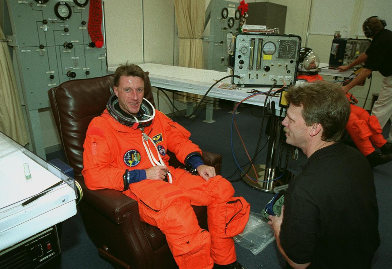 STS-103 Mission Specialist C. Michael Foale (Ph.D.) dons his launch and entry suit for the second time in two days before heading out to Launch Pad 39B and liftoff of Space Shuttle Discovery. The previous launch attempt on Dec. 17 was scrubbed about 8:52 p.m. due to numerous violations of weather launch commit criteria at KSC. Foale and other crew members Commander Curtis L. Brown Jr., Pilot Scott J. Kelly and Mission Specialists Steven L. Smith, John M. Grunsfeld (Ph.D.), Claude Nicollier of Switzerland and Jean-Francois Clervoy of France are scheduled to lift off at 7:50 p.m. EST Dec. 19 on mission STS-103, servicing the Hubble Space Telescope. Objectives for the nearly eight-day mission include replacing gyroscopes and an old computer, installing another solid state recorder, and replacing damaged insulation in the telescope. Discovery is expected to land at KSC Monday, Dec. 27, at about 5:24 p.m. EST
