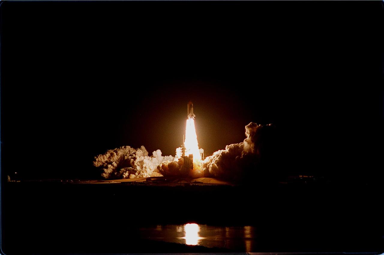Viewed from the roof of the Vehicle Assembly Building more than 3 miles away, the launch of Space Shuttle Discovery on mission STS-103 emblazes the night sky. Liftoff occurred at 7:50 p.m. EST from Launch Pad 39B. On board are Commander Curtis L. Brown Jr., Pilot Scott J. Kelly and Mission Specialists Steven L. Smith, C. Michael Foale (Ph.D.), John M. Grunsfeld (Ph.D.), Claude Nicollier of Switzerland and Jean-François Clervoy of France. Nicollier and Clervoy are with the European Space Agency. STS-103 is a Hubble Servicing Mission, with three planned space walks designed to install new equipment and replace old. The primary objective is to replace the gyroscopes that make up the three Rate Sensor Units. Extravehicular activities include installing a new computer, changing out one of the Fine Guidance Sensors, replacing a tape recorder with a new solid state recorder, and installing a voltage/temperature improvement kit, and begin repairing the insulation on the telescope's outer surface. After the 7-day, 21-hour mission, Discovery is targeted to land at KSC Monday, Dec. 27, at about 5:24 p.m. EST. This is the 27th flight of Discovery and the 96th mission in the Space Shuttle Program. It is the third launch at Kennedy Space Center in 1999