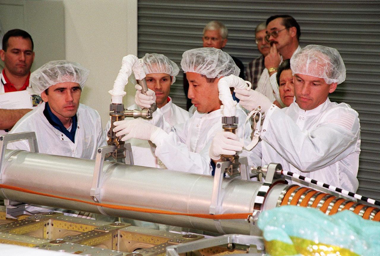 KENNEDY SPACE CENTER, FLA. -- During a Crew Equipment Interface Test (CEIT) at SPACEHAB, in Cape Canaveral, Fla., members of the STS-101 crew learn how to manipulate the Russian crane Strela. At left is Yuri Malenchenko, who is with the Russian Space Agency (RSA); in the center is Edward Tsang Lu (Ph.D.); at right is Mission Specialist Jeffrey N. Williams. Other crew members are Commander James Donald Halsell Jr., Pilot Scott Horowitz, and Mission Specialists Mary Ellen Weber, (Ph.D.) and Boris W. Morukov (RSA). The primary objective of the STS-101 mission is to complete the initial outfitting of the International Space Station, making it fully ready for the first long-term crew. The seven-member crew will transfer almost two tons of equipment and supplies from SPACEHAB's Logistics Double Module. Additionally, they will unpack a shipment of supplies delivered earlier by a Russian Progress space tug and begin outfitting the newly arrived Zvezda Service Module. Three astronauts will perform two space walks to transfer and install parts of the Russian Strela cargo boom that are attached to SPACEHAB's Integrated Cargo Container, connect utility cables between Zarya and Zvezda, and install a magnetometer/pole assembly on the Service Module. Additional activities for the STS-101 astronauts include working with the Space Experiment Module (SEM-06) and the Mission to America's Remarkable Schools (MARS), two educational initiatives. STS-101 is scheduled for launch no earlier than March 16, 2000