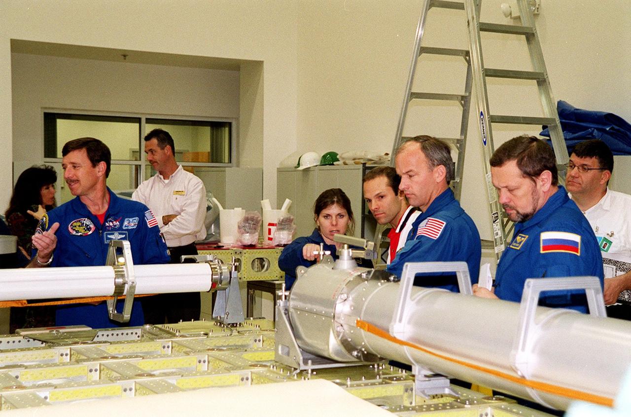 KENNEDY SPACE CENTER, FLA. -- During a Crew Equipment Interface Test (CEIT) at SPACEHAB, in Cape Canaveral, Fla., STS-101 crew members check out some of the cargo that will be carried on their mission. From left are Pilot Scott J. "Doc" Horowitz (Ph.D.) and Mission Specialists Mary Ellen Weber, (Ph.D.), Jeffrey N. Williams, and Boris W. Morukov, who is with the Russian Space Agency (RSA). Other crew members are Commander James Donald Halsell Jr., Edward Tsang Lu (Ph.D.) and Yuri Malenchenko, also with RSA. The primary objective of the STS-101 mission is to complete the initial outfitting of the International Space Station, making it fully ready for the first long-term crew. The seven-member crew will transfer almost two tons of equipment and supplies from SPACEHAB's Logistics Double Module. Additionally, they will unpack a shipment of supplies delivered earlier by a Russian Progress space tug and begin outfitting the newly arrived Zvezda Service Module. Three astronauts will perform two space walks to transfer and install parts of the Russian Strela cargo boom that are attached to SPACEHAB's Integrated Cargo Container, connect utility cables between Zarya and Zvezda, and install a magnetometer/pole assembly on the Service Module. Additional activities for the STS-101 astronauts include working with the Space Experiment Module (SEM-06) and the Mission to America's Remarkable Schools (MARS), two educational initiatives. STS-101 is scheduled for launch no earlier than March 16, 2000