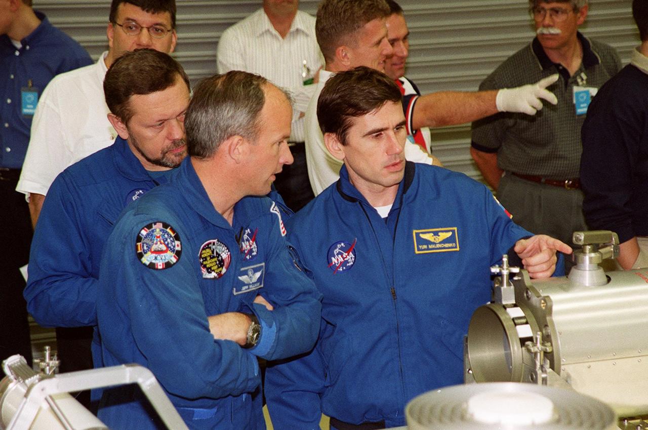 KENNEDY SPACE CENTER, FLA. -- During a Crew Equipment Interface Test (CEIT) at SPACEHAB, in Cape Canaveral, Fla., STS-101 crew members check out some of the cargo that will be carried on their mission. From left are Mission Specialists Boris W. Morukov, who is with the Russian Space Agency (RSA), Jeffrey N. Williams, and Yuri Malenchenko, also with RSA. Other crew members are Commander James Donald Halsell Jr., Pilot Scott J. "Doc" Horowitz (Ph.D.) and Mission Specialists Mary Ellen Weber, (Ph.D.) and Edward Tsang Lu (Ph.D.). The primary objective of the STS-101 mission is to complete the initial outfitting of the International Space Station, making it fully ready for the first long-term crew. The seven-member crew will transfer almost two tons of equipment and supplies from SPACEHAB's Logistics Double Module. Additionally, they will unpack a shipment of supplies delivered earlier by a Russian Progress space tug and begin outfitting the newly arrived Zvezda Service Module. Three astronauts will perform two space walks to transfer and install parts of the Russian Strela cargo boom that are attached to SPACEHAB's Integrated Cargo Container, connect utility cables between Zarya and Zvezda, and install a magnetometer/pole assembly on the Service Module. Additional activities for the STS-101 astronauts include working with the Space Experiment Module (SEM-06) and the Mission to America's Remarkable Schools (MARS), two educational initiatives. STS-101 is scheduled for launch no earlier than March 16, 2000