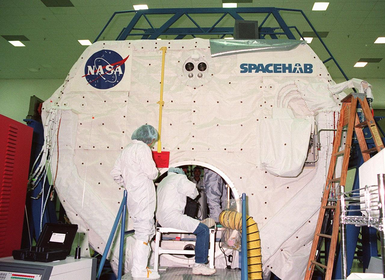 KENNEDY SPACE CENTER, FLA. -- At SPACEHAB, in Titusville, Fla., STS-101 crew members take part in a Crew Equipment Interface Test (CEIT). Here they are checking out the SPACEHAB Logistics Double Module. The crew is composed of Commander James Donald Halsell Jr., Pilot Scott J. "Doc" Horowitz (Ph.D.), and Mission Specialists Mary Ellen Weber (Ph.D.), Edward Tsang Lu (Ph.D.), Jeffrey N. Williams, and Yuri Malenchenko and Boris W. Morukov, who are with the Russian Space Agency. The primary objective of the STS-101 mission is to complete the initial outfitting of the International Space Station, making it fully ready for the first long-term crew. The seven-member crew will transfer almost two tons of equipment and supplies from SPACEHAB. Additionally, they will unpack a shipment of supplies delivered earlier by a Russian Progress space tug and begin outfitting the newly arrived Zvezda Service Module. Three astronauts will perform two space walks to transfer and install parts of the Russian Strela cargo boom that are attached to SPACEHAB's Integrated Cargo Container, connect utility cables between Zarya and Zvezda, and install a magnetometer/pole assembly on the Service Module. Additional activities for the STS-101 astronauts include working with the Space Experiment Module (SEM-06) and the Mission to America's Remarkable Schools (MARS), two educational initiatives. STS-101 is scheduled for launch no earlier than March 16, 2000
