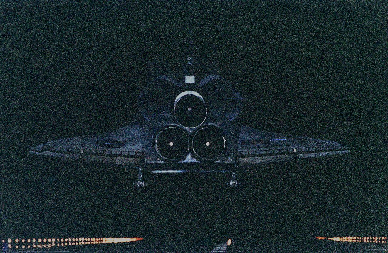 KENNEDY SPACE CENTER, Fla. -- The orbiter Discovery looks like a blue ghost as it drops from the darkness onto lighted runway 33 at KSC's Shuttle Landing Facility. After traveling more than 3,267,000 miles on a successful eight-day mission to service the Hubble Space Telescope, the orbiter touches down at 7:00:47 p.m. EST. Aboard are Commander Curtis L. Brown Jr., Pilot Scott J. Kelly, and Mission Specialists Steven L. Smith, C. Michael Foale (Ph.D.), John M. Grunsfeld (Ph.D.), Claude Nicollier of Switzerland and Jean-François Clervoy of France, who spent the Christmas holiday in space in order to accomplish their mission before the end of 1999. During the mission, Discovery's four space-walking astronauts, Smith, Foale, Grunsfeld and Nicollier, spent 24 hours and 33 minutes upgrading and refurbishing Hubble, making it more capable than ever to renew its observations of the universe. Mission objectives included replacing gyroscopes and an old computer, installing another solid state recorder, and replacing damaged insulation in the telescope. Hubble was released from the end of Discovery's robot arm on Christmas Day. This was the 96th flight in the Space Shuttle program and the 27th for the orbiter Discovery. The landing was the 20th consecutive Shuttle landing in Florida and the 13th night landing in Shuttle program history