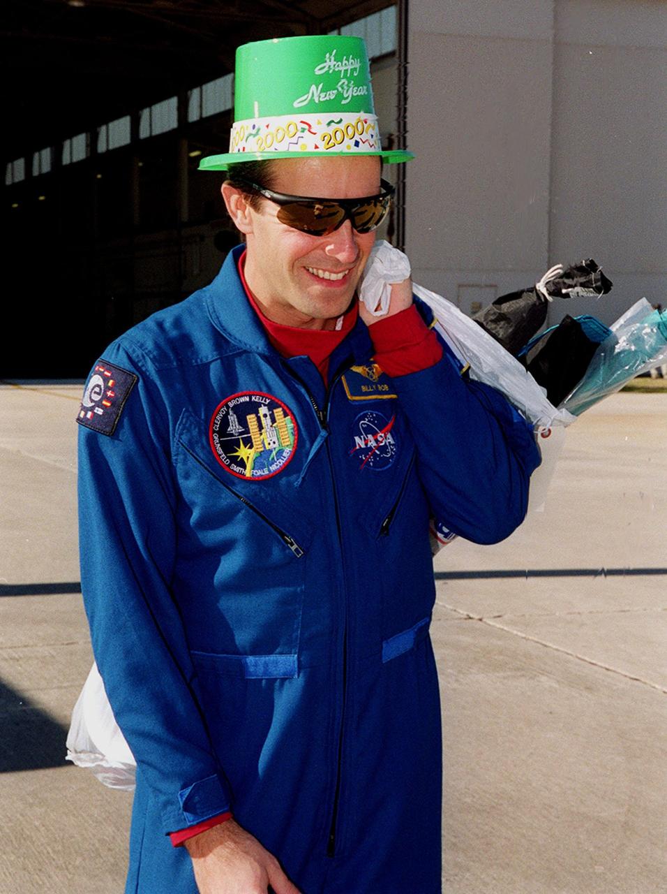 STS-103 Mission Specialist Jean-François Clervoy of France exhibits his holiday spirit on the runway at Patrick Air Force Base. The STS-103 crew and their families are preparing to board an airplane that will return them to their home base at the Johnson Space Center in Houston following the successful completion of their mission. Discovery landed in darkness the previous evening, Dec. 27, on runway 33 at KSC's Shuttle Landing Facility at 7:00:47 p.m. EST. This was the first time that a Shuttle crew spent the Christmas holiday in space. The other STS-103 crew members are Commander Curtis L. Brown Jr.; Pilot Scott J. Kelly; and Mission Specialists Steven L. Smith, C. Michael Foale (Ph.D.), John M. Grunsfeld (Ph.D.), and Claude Nicollier of Switzerland. The STS-103 mission supplied the Hubble Space Telescope with six new gyroscopes, six new voltage/temperature improvement kits, a new onboard computer, a new solid state recorder and new data transmitter, and a new fine guidance sensor along with new insulation on parts of the orbiting telescope. This was the 96th flight in the Space Shuttle program and the 27th for the orbiter Discovery