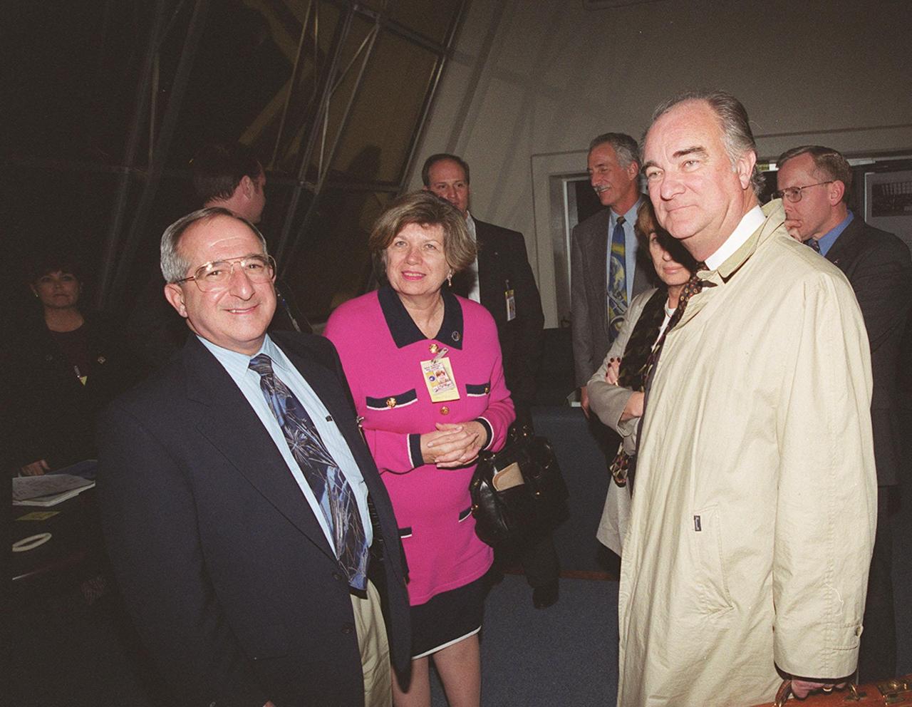 On hand in the Firing Room to watch the launch of STS-103 are (left to right) Joseph Rothenberg, associate administrator, Office of Space Flight; JoAnn Morgan, associate director for Advanced Development and Shuttle Upgrades; and Francois Bujon de L'Estang, ambassador of France. Behind the ambassador is his wife, Madam de L'Estang. One of the STS-103 crew, Mission Specialist Jean-Francois Clervoy, is from France, and a member of the European Space Agency (ESA). Other crew members are Commander Curtis L. Brown Jr. , Pilot Scott J. Kelly and Mission Specialists Steven L. Smith, C. Michael Foale (Ph.D.), John M. Grunsfeld (Ph.D.) and Claude Nicollier of Switzerland (also with ESA). The mission, to service the Hubble Space Telescope, is scheduled for launch Dec. 19 at 7:50 p.m. EST from Launch Pad 39B. Mission objectives include replacing gyroscopes and an old computer, installing another solid state recorder, and replacing damaged insulation in the telescope. After the 7-day, 21-hour mission, Discovery is expected to land at KSC Monday, Dec. 27, at about 5:24 p.m. ES