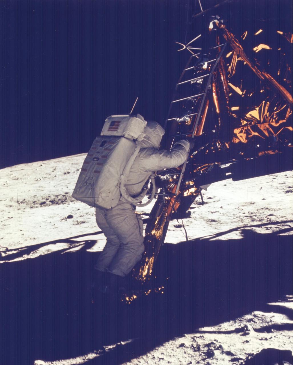 JOHNSON SPACE CENTER, HOUSTON, TEXAS - Apollo 11 Onboard Film -- Astronaut Edwin E. Aldrin Jr., Lunar Module (LM) pilot, descends the steps of the Lunar module ladder as he prepares to walk on the Moon.  He had just egressed the LM.  This picture was taken by astronaut Neil A. Armstrong, commander, with a 70-mm lunar surface camera during the Apollo 11 extravehicular activity.