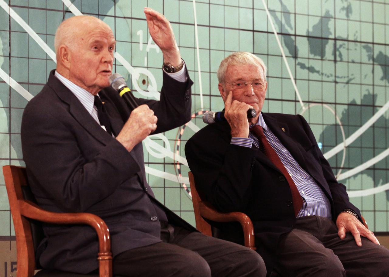 Mercury astronauts John Glenn, left, and Scott Carpenter sit in front of the plot board from the Mercury control center on display at the Kennedy Space Center Visitor Complex. The astronauts, part of the original class of seven astronauts chosen by NASA, were taking part in a question-and-answer session with the media as part of events celebrating 50 years of Americans in orbit, an era which began with John Glenn's Mercury mission MA-6, on Feb. 20, 1962. Glenn's launch aboard an Atlas rocket took with it the hopes of an entire nation and ushered in a new era of space travel that eventually led to Americans walking on the moon by the end of the 1960s. Glenn soon was followed into orbit by Carpenter, Walter Schirra and Gordon Cooper. Their fellow Mercury astronauts Alan Shepard and Virgil "Gus" Grissom flew earlier suborbital flights. Deke Slayton was grounded by a medical condition until the Apollo-Soyuz Test Project in 1975.