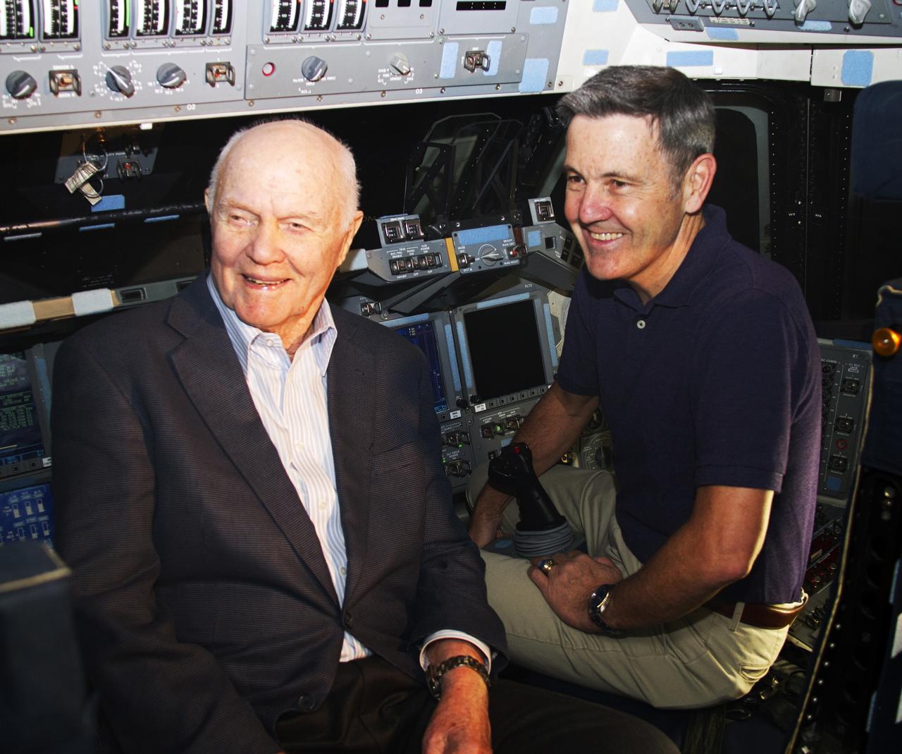 John Glenn and NASA Kennedy Space Center Director Bob Cabana sit in the flight deck of space shuttle Discovery in Bay 1 of the Orbiter Processing Facility at NASA's Kennedy Space Center in Florida. Glenn is at the space center to mark the 50th anniversary of being the first American astronaut to orbit the Earth inside the NASA Mercury Project's Friendship 7 capsule on Feb. 20, 1962. Glenn later returned to space in October 1998 as a payload specialist aboard Discovery's STS-95 mission. Glenn's launch aboard an Atlas rocket took with it the hopes of an entire nation and ushered in a new era of space travel that eventually led to Americans walking on the moon by the end of the 1960s. Glenn soon was followed into orbit by Scott Carpenter, Walter Schirra and Gordon Cooper. Their fellow Mercury astronauts Alan Shepard and Virgil "Gus" Grissom flew earlier suborbital flights. Deke Slayton, a member of NASA's original Mercury 7 astronauts, was grounded by a medical condition until the Apollo-Soyuz Test Project in 1975. Shuttle Discovery currently is being prepared for display at Smithsonian’s National Air and Space Museum, Steven F. Udvar-Hazy Center in Chantilly, Virginia.