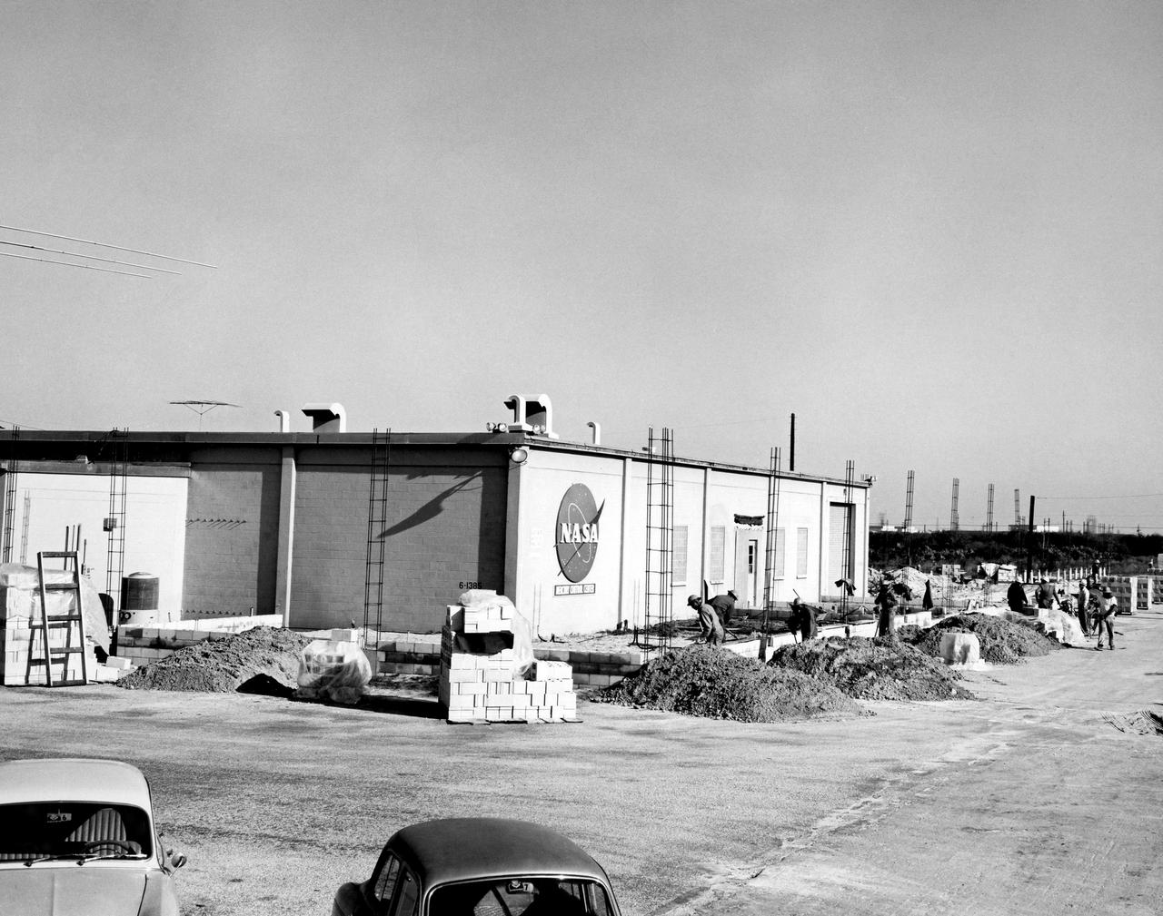 CAPE CANAVERAL, Fla. - Between 1962 and 1963, the Mission Control Center was modified to handle the additional complexities of the Gemini Program. In 1962, Pan American World Airways Inc. was contracted to design an addition to the facility, which wrapped around the east, north, and most of the west and south sides.           The Mercury Mission Control Center in Florida played a key role in the United States' early spaceflight program. Located at Cape Canaveral Air Force Station, the original part of the building was constructed between 1956 and 1958, with additions in 1959 and 1963. The facility officially was transferred to NASA on Dec. 26, 1963, and served as mission control during all the Project Mercury missions, as well as the first three flights of the Gemini Program, when it was renamed Mission Control Center. With its operational days behind, on June 1, 1967, the Mission Control Center became a stop on the public tour of NASA facilities until the mid-90s. In 1999, much of the equipment and furnishings from the Flight Control Area were moved to the Kennedy Space Center Visitor Complex where they became part of the exhibit there. The building was demolished in spring 2010. Photo credit: NASA