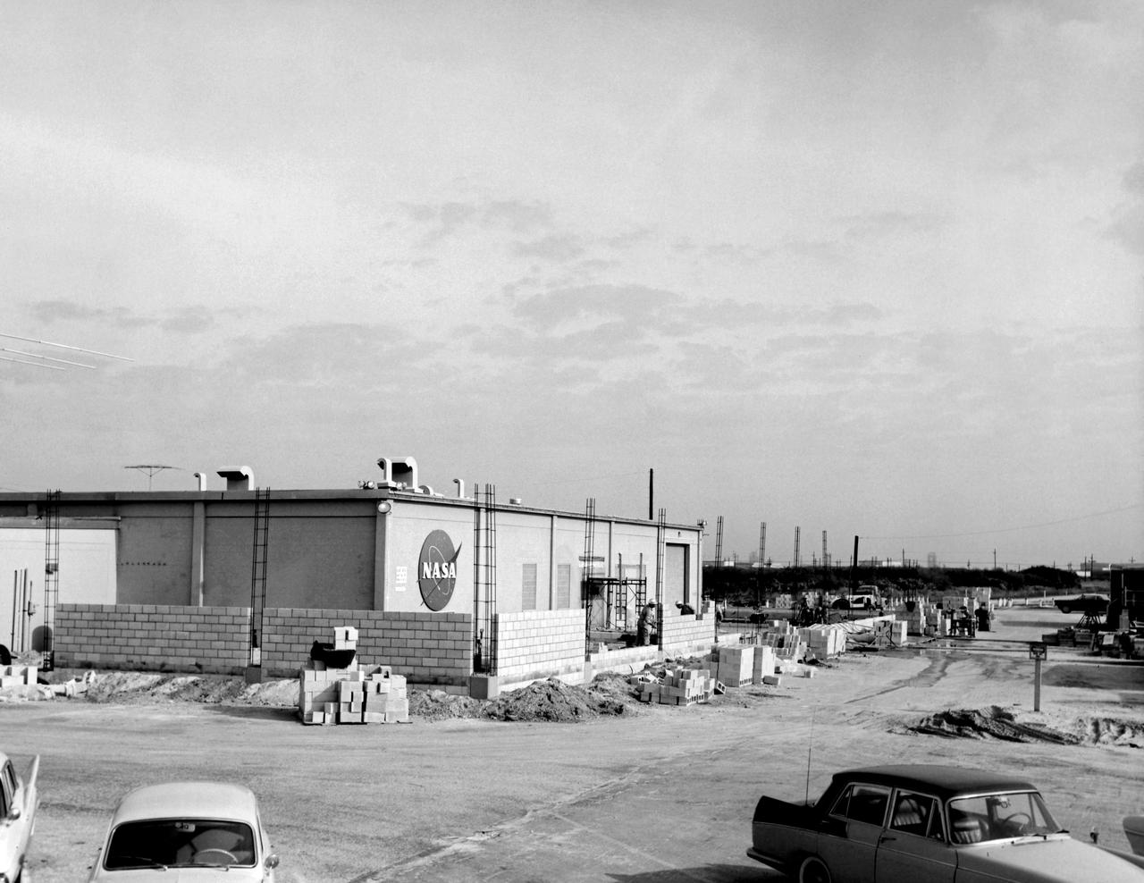 CAPE CANAVERAL, Fla. - Between 1962 and 1963, the Mission Control Center was modified to handle the additional complexities of the Gemini Program. In 1962, Pan American World Airways Inc. was contracted to design an addition to the facility, which wrapped around the east, north, and most of the west and south sides.           The Mercury Mission Control Center in Florida played a key role in the United States' early spaceflight program. Located at Cape Canaveral Air Force Station, the original part of the building was constructed between 1956 and 1958, with additions in 1959 and 1963. The facility officially was transferred to NASA on Dec. 26, 1963, and served as mission control during all the Project Mercury missions, as well as the first three flights of the Gemini Program, when it was renamed Mission Control Center. With its operational days behind, on June 1, 1967, the Mission Control Center became a stop on the public tour of NASA facilities until the mid-90s. In 1999, much of the equipment and furnishings from the Flight Control Area were moved to the Kennedy Space Center Visitor Complex where they became part of the exhibit there. The building was demolished in spring 2010. Photo credit: NASA