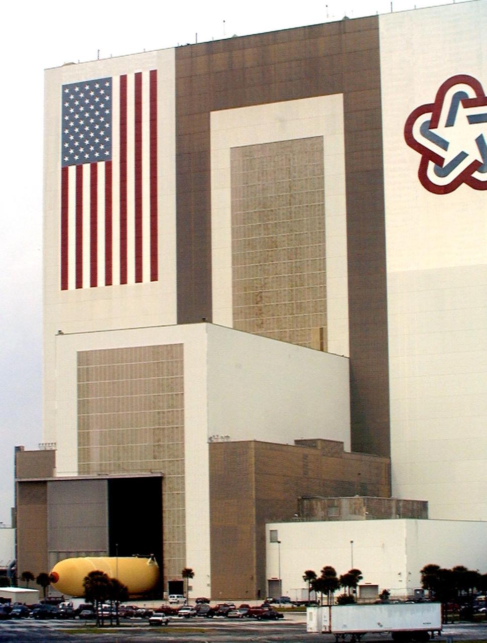 The Space Shuttle's first super lightweight external tank is on its way to Kennedy Space Center's Vehicle Assembly Building for processing. The tank, which is scheduled for flight on STS-91 in late May, arrived Feb. 3 in Port Canaveral, where it remained until Feb. 6 due to high winds. The improved tank is 7,500 pounds lighter than its predecessors and was developed to increase the Shuttle payload capacity on International Space Station assembly flights. Major changes to the lighter tank include the use of new materials and a revised internal design. The new liquid oxygen and liquid hydrogen tanks are constructed of aluminum lithium a lighter, stronger material than the metal alloy currently used. The redesigned walls of the liquid hydrogen tank were machined to provide additional strength and stability as well