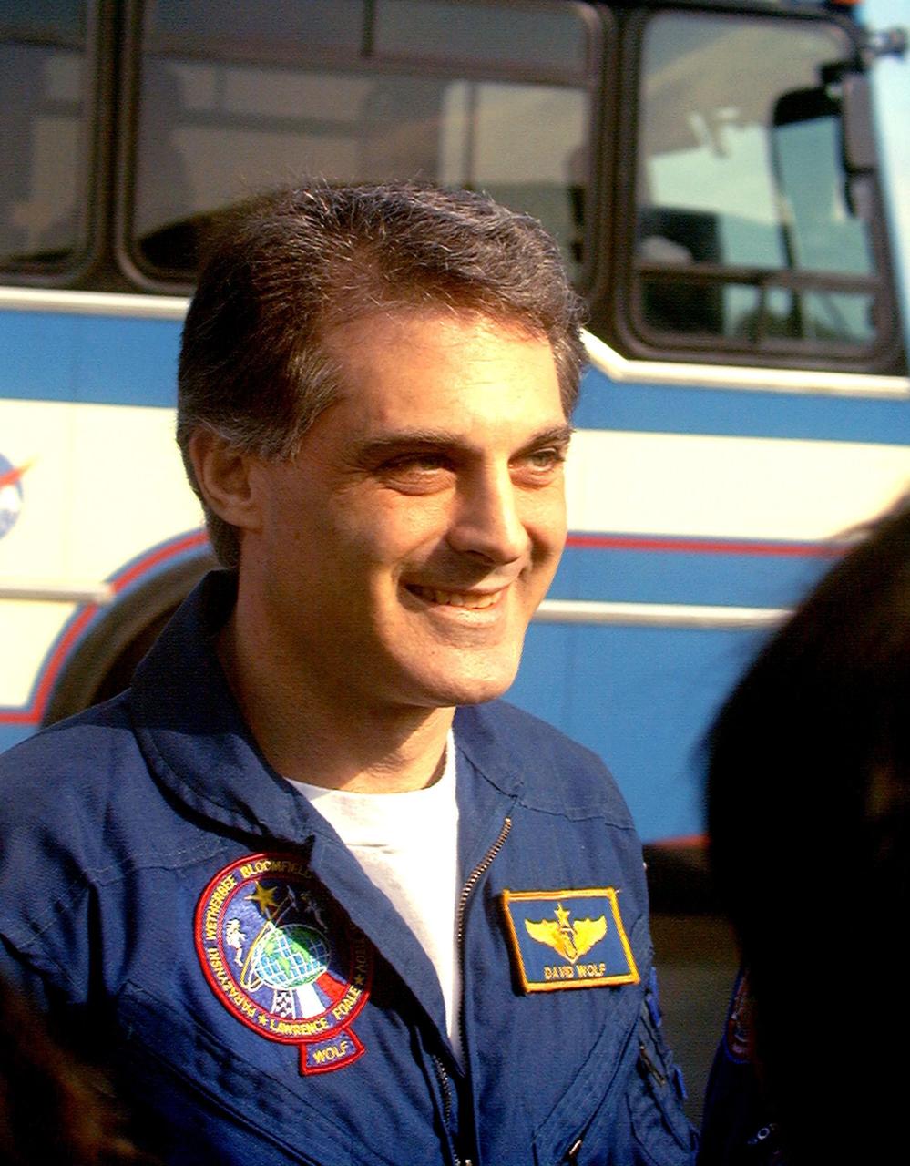 NASA astronaut and Mir 24 crew member David Wolf, M.D., enjoys a moment with the media at the Skid Strip at Cape Canaveral Air Station on Feb. 1 moments before his departure for Johnson Space Center. The STS-89 crew that brought Dr. Wolf back to Earth arrived at KSC aboard the orbiter Endeavour Jan. 31, concluding the eighth Shuttle-Mir docking mission. STS-89 Mission Specialist Andrew Thomas, Ph.D., succeeded Dr. Wolf on Mir and is scheduled to remain on the Russian space station until the STS-91 Shuttle mission returns in June 1998. In addition to the docking and crew exchange, STS-89 included the transfer of science, logistical equipment and supplies between the two orbiting spacecrafts
