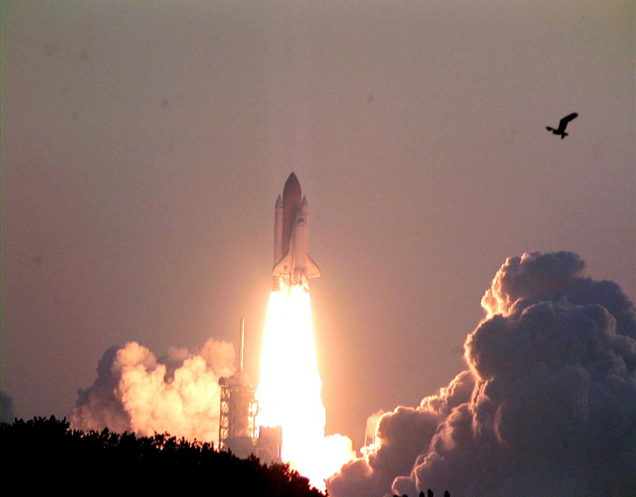 Launched on time at 6:49:42 a.m. EDT, Space Shuttle Discovery blasts through a gossamer sky on mission STS-96. A 10-day logistics and resupply mission for the International Space Station, STS-96 is carrying about 4,000 pounds of supplies, to be stored aboard the station for use by future crews, including laptop computers, cameras, tools, spare parts, and clothing. The mission also includes such payloads as a Russian crane, the Strela; a U.S.-built crane; the Spacehab Oceaneering Space System Box (SHOSS), a logistics items carrier; and STARSHINE, a student-involved experiment. It will include a space walk to attach the cranes to the outside of the ISS for use in future construction. Landing is expected at the SLF on June 6 about 1:58 a.m. EDT