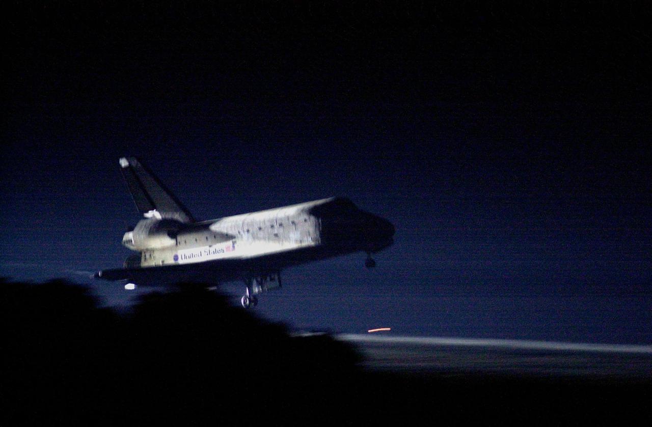 KENNEDY SPACE CENTER, Fla. -- Landing lights illuminate Space Shuttle Atlantis as it approaches touchdown on KSC’s Shuttle Landing Facility Runway 15 to complete the 9-day, 20-hour, 9-minute-long STS-101 mission. At the controls are Commander James D. Halsell Jr. and Pilot Scott “Doc” Horowitz. Also onboard the orbiter are Mission Specialists Mary Ellen Weber, James S. Voss, Jeffrey N. Williams, Susan J. Helms and Yury Usachev of Russia. The crew is returning from the third flight to the International Space Station. This was the 98th flight in the Space Shuttle program and the 21st for Atlantis, also marking the 51st landing at KSC, the 22nd consecutive landing at KSC, and the 29th in the last 30 Shuttle flights. Main gear touchdown was at 2:20:17 a.m. EDT, landing on orbit 155 of the mission. Nose gear touchdown was at 2:20:30 a.m. EDT, and wheel stop at 2:21:19 a.m. EDT
