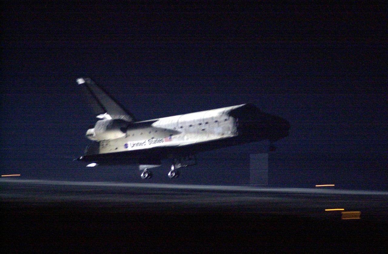 KENNEDY SPACE CENTER, Fla. -- Glowing in the lights from Runway 15, Space Shuttle Atlantis nears touchdown at KSC’s Shuttle Landing Facility after completing the 9-day, 20-hour, 9-minute-long STS-101 mission. At the controls are Commander James D. Halsell Jr. and Pilot Scott “Doc” Horowitz. Also onboard the orbiter are Mission Specialists Mary Ellen Weber, James S. Voss, Jeffrey N. Williams, Susan J. Helms and Yury Usachev of Russia. The crew is returning from the third flight to the International Space Station. This was the 98th flight in the Space Shuttle program and the 21st for Atlantis, also marking the 51st landing at KSC, the 22nd consecutive landing at KSC, and the 29th in the last 30 Shuttle flights. Main gear touchdown was at 2:20:17 a.m. EDT, landing on orbit 155 of the mission. Nose gear touchdown was at 2:20:30 a.m. EDT, and wheel stop at 2:21:19 a.m. EDT