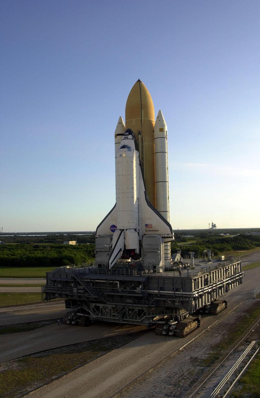 KENNEDY SPACE CENTER, Fla. -- As the early morning sky lights up, Space Shuttle Endeavour inches its way to Launch Pad 39B (on the horizon) via the crawlerway that leads from the Vehicle Assembly Building. The Shuttle is atop the Mobile Launcher Platform (MLP). Visible beneath the MLP is the crawler-transporter, which moves on four double-tracked crawlers. Each shoe on the crawler track weighs a ton. Unloaded, the transporter weighs 6 million pounds and moves at 2 mph. The maximum speed of the loaded transporter is 1 mph. Endeavour is scheduled to be launched Nov. 30 at 10:01 p.m. EST on mission STS-97, the sixth construction flight to the International Space Station. Its payload includes the P6 Integrated Truss Structure and a photovoltaic (PV) module, with giant solar arrays that will provide power to the Station. The mission includes two spacewalks to complete the solar array connections