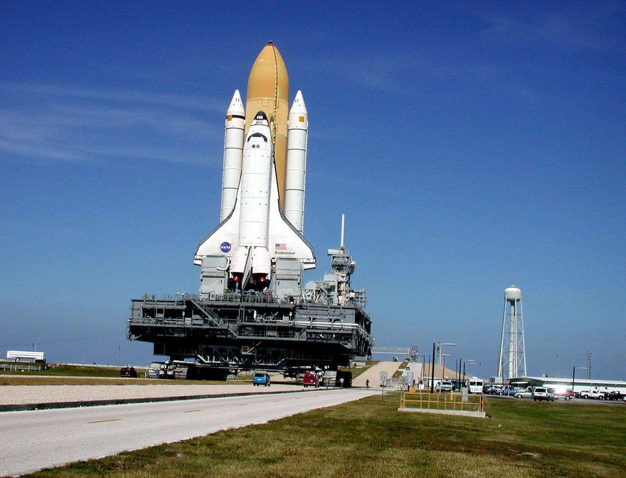 KENNEDY SPACE CENTER, Fla. -- Perched atop the Mobile Launcher Platform, Space Shuttle Endeavour approaches the gate to Launch Pad 39B. To the right of the pad is a 290-foot tall water tower. Endeavour is scheduled to be launched Nov. 30 at 10:01 p.m. EST on mission STS-97, the sixth construction flight to the International Space Station. Its payload includes the P6 Integrated Truss Structure and a photovoltaic (PV) module, with giant solar arrays that will provide power to the Station. The mission includes two spacewalks to complete the solar array connections