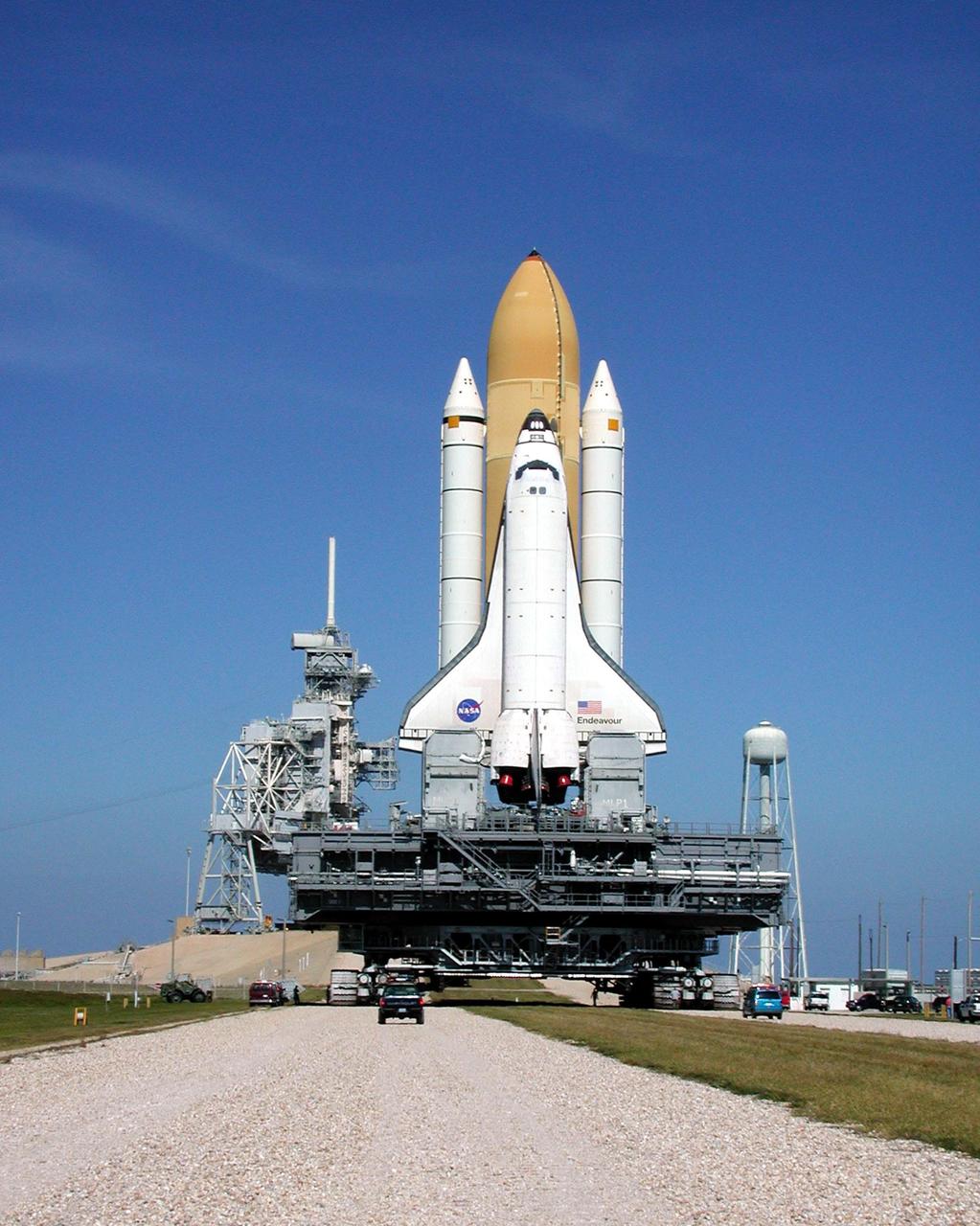 KENNEDY SPACE CENTER, Fla. -- Perched atop the Mobile Launcher Platform, Space Shuttle Endeavour is nearly through the gate to Launch Pad 39B. To the right of the pad is a 290-foot tall water tower. To the left is the Fixed Service Structure and Rotating Service Structure. Endeavour is scheduled to be launched Nov. 30 at 10:01 p.m. EST on mission STS-97, the sixth construction flight to the International Space Station. Its payload includes the P6 Integrated Truss Structure and a photovoltaic (PV) module, with giant solar arrays that will provide power to the Station. The mission includes two spacewalks to complete the solar array connections