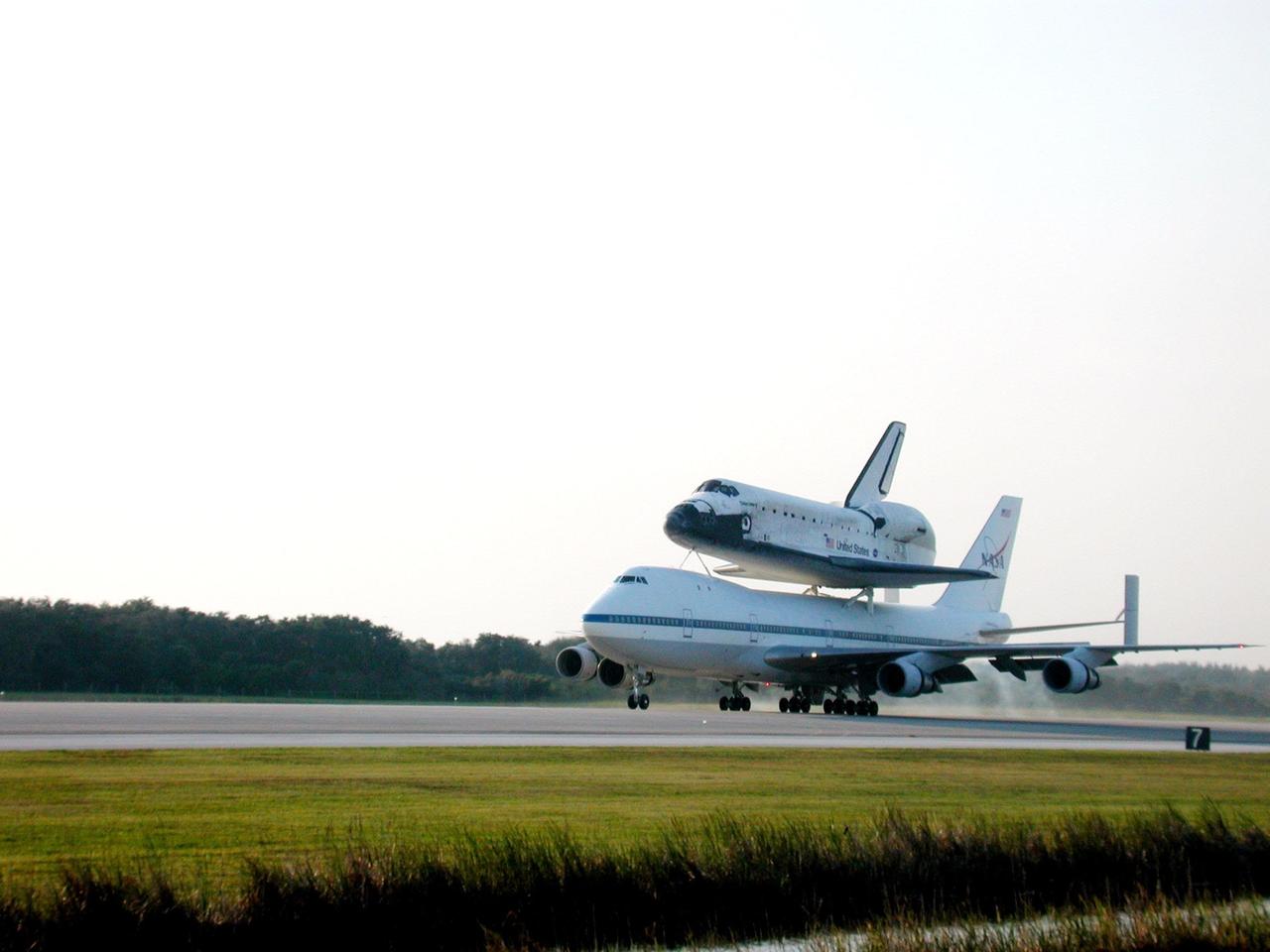 On a warm afternoon, the Shuttle Carrier Aircraft (SCA), with its unique orbiter passenger attached to its back, rolls down the runway at KSC’s Shuttle Landing Facility. The SCA is returning Discovery to KSC after the orbiter’s California landing more than a week ago at Edwards Air Force Base at the end of mission STS-92. Discovery will be demated from the SCA via the mate/demate device at the SLF and transported to the Orbiter Processing Facility bay 1. There it will undergo preparations for its next launch, STS-102, scheduled for February 2001