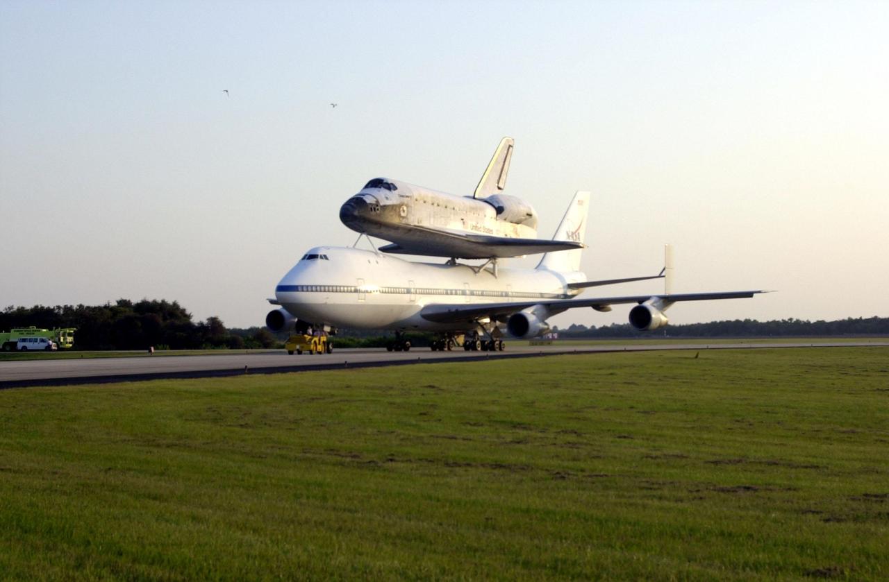 Catching the glow of the late afternoon sun, the Shuttle Carrier Aircraft (SCA) rolls down the runway at the Shuttle Landing Facility as it returns the orbiter Discovery to KSC. The ferry flight started in California after the orbiter’s landing more than a week ago at Edwards Air Force Base at the end of mission STS-92. Discovery wears a tail cone protecting its aft nozzles for the ferry flight. Discovery will be demated from the SCA via the mate/demate device at the SLF and transported to the Orbiter Processing Facility bay 1. There it will undergo preparations for its next launch, STS-102, scheduled for February 2001