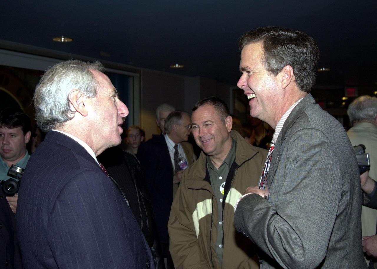 KENNEDY SPACE CENTER, FLA. -- Enjoying a light moment before the launch of Space Shuttle Endeavour on mission STS-97 are NASA Administrator Daniel Goldin (left) and Florida Governor Jeb Bush (right). Between them is California Congressman Dana Rohrabacher.; Guests of NASA, they viewed the launch from the Banana Creek VIP Site. Liftoff of Endeavour occurred on time at 10:06:01 p.m. EST with a crew of five. The sixth construction flight to the International Space Station, Endeavour is transporting the P6 Integrated Truss Structure that comprises Solar Array Wing-3 and the Integrated Electronic Assembly, to provide power to the Space Station. The 11-day mission includes two spacewalks to complete the solar array connections. Endeavour is expected to land Dec. 11 at 6:19 p.m. EST