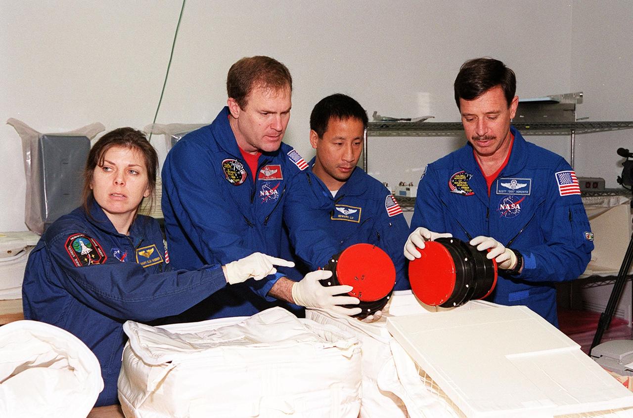 KENNEDY SPACE CENTER, FLA. -- At SPACEHAB, in Cape Canaveral, the STS-101 crew inspect equipment and payload for their mission. From left to right are Mission Specialist Mary Ellen Weber (Ph.D.) , Commander James D. Halsell Jr., Mission Specialist Edward Tsang Lu and Pilot Scott J. "Doc" Horowitz (Ph.D.). They are taking part in a Crew Equipment Interface Test, which gives them an opportunity to look over equipment and payloads that will fly on the mission. Space Shuttle Atlantis will be carrying the SPACEHAB Double Module, which carries internal logistics and resupply cargo for station outfitting. Launch of Atlantis on mission STS-101 is scheduled no earlier than April 13, 2000