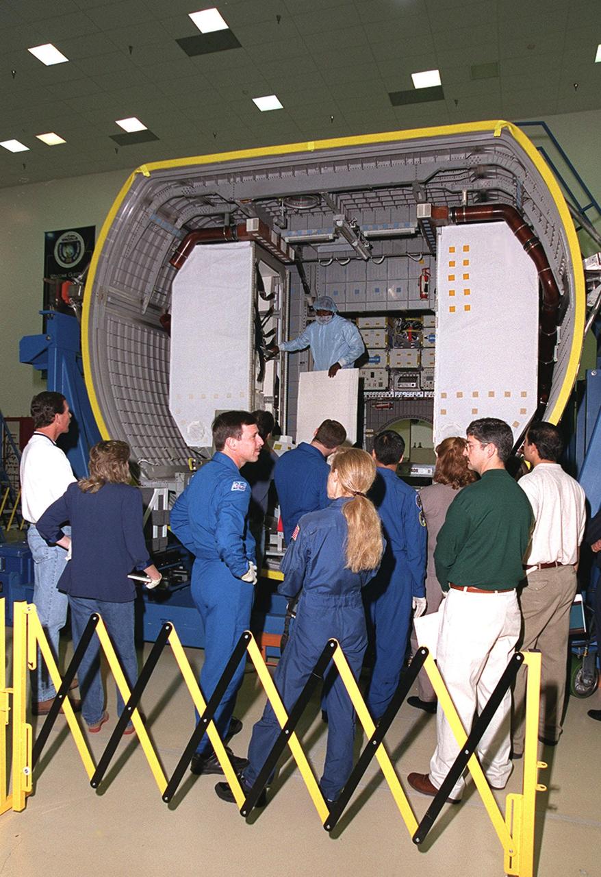 At SPACEHAB, in Cape Canaveral, the STS-101 crew look over the SPACEHAB Double Module, part of the payload for their mission. Gathered in the center of the onlookers are (in uniform) are (rear) Pilot Scott J. "Doc" Horowitz (Ph.D) and Mission Specialist Mary Ellen Weber (Ph.D.); in front of them, Commander James D. Halsell Jr. and Mission Specialist Edward Tsang Lu. They are taking part in a Crew Equipment Interface Test, which gives them an opportunity to look over equipment and payloads that will fly on the mission. Space Shuttle Atlantis will be carrying the SPACEHAB Double Module, which carries internal logistics and resupply cargo for station outfitting. Launch of Atlantis on mission STS-101 is scheduled no earlier than April 13, 2000