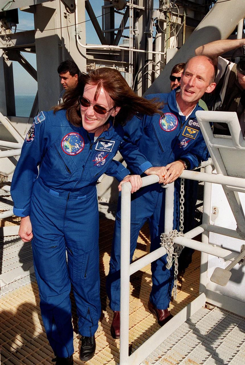 KENNEDY SPACE CENTER, Fla. -- On the Fixed Service Structure at Launch Pad 39A, STS-99 Mission Specialists Janet Lynn Kavandi (Ph.D.) and Gerhard Thiele, who is with the European Space Agency, look over the emergency egress equipment. The crew are taking part in Terminal Countdown Demonstration Test activities, which provide them with simulated countdown exercises, emergency egress training, and opportunities to inspect the mission payloads in the orbiter's payload bay. STS-99 is the Shuttle Radar Topography Mission, which will chart a new course, using two antennae and a 200-foot-long section of space station-derived mast protruding from the payload bay to produce unrivaled 3-D images of the Earth's surface. The result of the Shuttle Radar Topography Mission could be close to 1 trillion measurements of the Earth's topography. Besides contributing to the production of better maps, these measurements could lead to improved water drainage modeling, more realistic flight simulators, better locations for cell phone towers, and enhanced navigation safety. Launch of Endeavour on the 11-day mission is scheduled for Jan. 31 at 12:47 p.m. EST