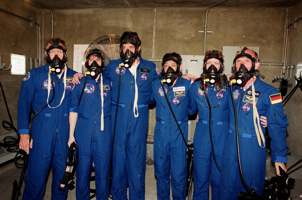 KENNEDY SPACE CENTER, Fla. --  In the bunker at Launch Pad 39A, the STS-99 crew try on oxygen masks. From left are Pilot Dominic Gorie, Mission Specialist Janice Voss (Ph.D.), Commander Kevin Kregel, and Mission Specialists Mamoru Mohri, Janet Lynn Kavandi (Ph.D.) and Gerhard Thiele. Mohri is with the National Space Development Agency (NASDA) of Japan and Thiele is with the European Space Agency. The crew are taking part in Terminal Countdown Demonstration Test activities, which provide them with simulated countdown exercises, emergency egress training, and opportunities to inspect the mission payloads in the orbiter's payload bay. STS-99 is the Shuttle Radar Topography Mission, which will chart a new course, using two antennae and a 200-foot-long section of space station-derived mast protruding from the payload bay to produce unrivaled 3-D images of the Earth's surface. The result of the Shuttle Radar Topography Mission could be close to 1 trillion measurements of the Earth's topography. Besides contributing to the production of better maps, these measurements could lead to improved water drainage modeling, more realistic flight simulators, better locations for cell phone towers, and enhanced navigation safety. Launch of Endeavour on the 11-day mission is scheduled for Jan. 31 at 12:47 p.m. EST