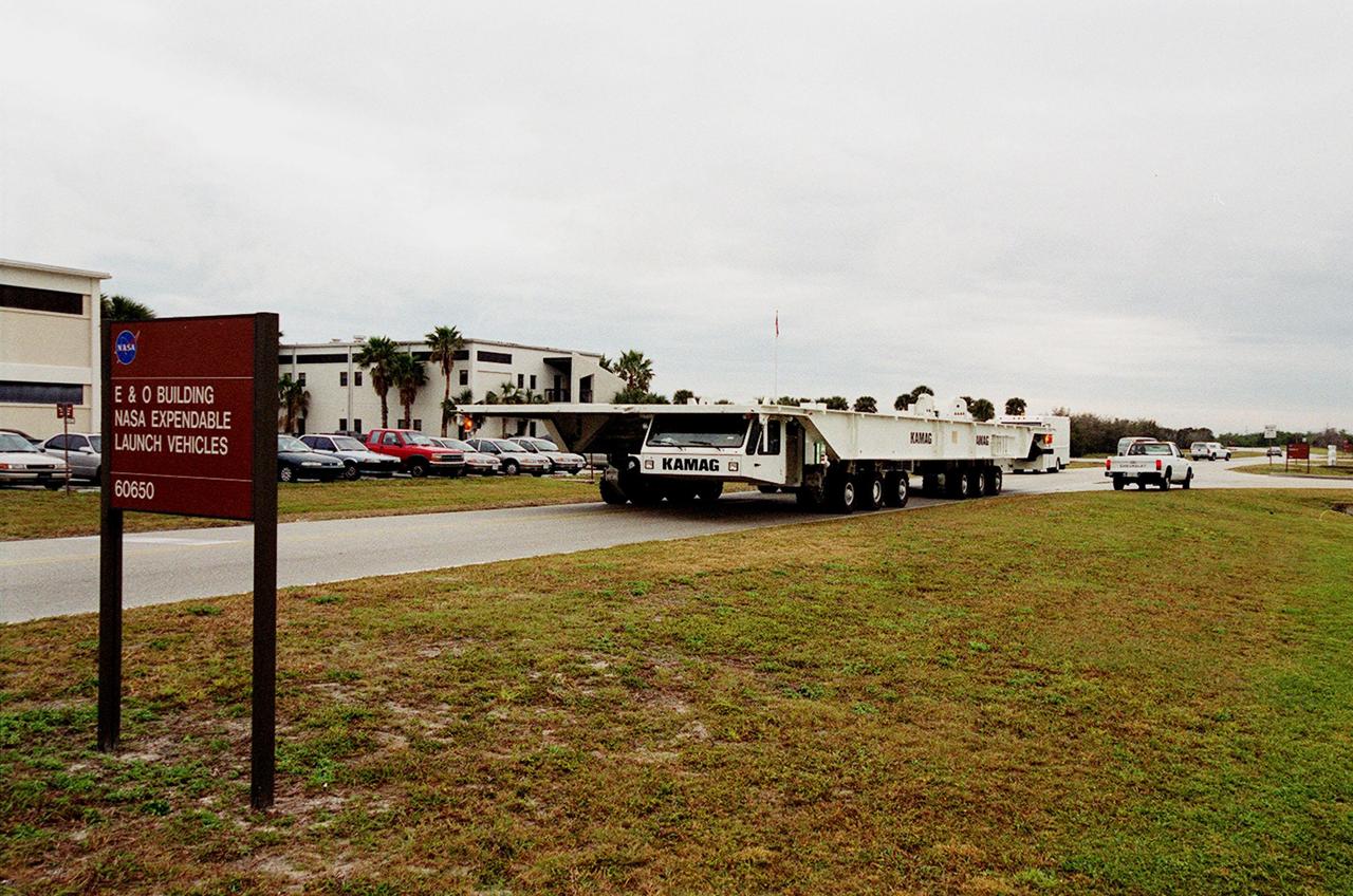 One of two new payload transporters for Kennedy Space Center moves through Cape Canaveral Air Station after being unloaded from a barge at Port Canaveral. The transporters, manufactured by the KAMAG Transporttechnick, GmbH, of Ulm, Germany, are replacing the existing Payload Canister Transporter system, which is 20 years old. Each transporter is 65 feet long and 22 feet wide and has 24 tires divided between its two axles. The transporter travels 10 miles per hour unloaded, 5 miles per hour when loaded; it weighs up to 172,000 pounds when the canister with payloads rides atop. The transporters will be outfitted with four subsystems for monitoring the environment inside the canister during the payload moves: the Electrical Power System, Environmental Control System, Instrumentation and Communications System, and the Fluids and Gases System. Engineers and technicians are being trained on the transporter's operation and maintenance