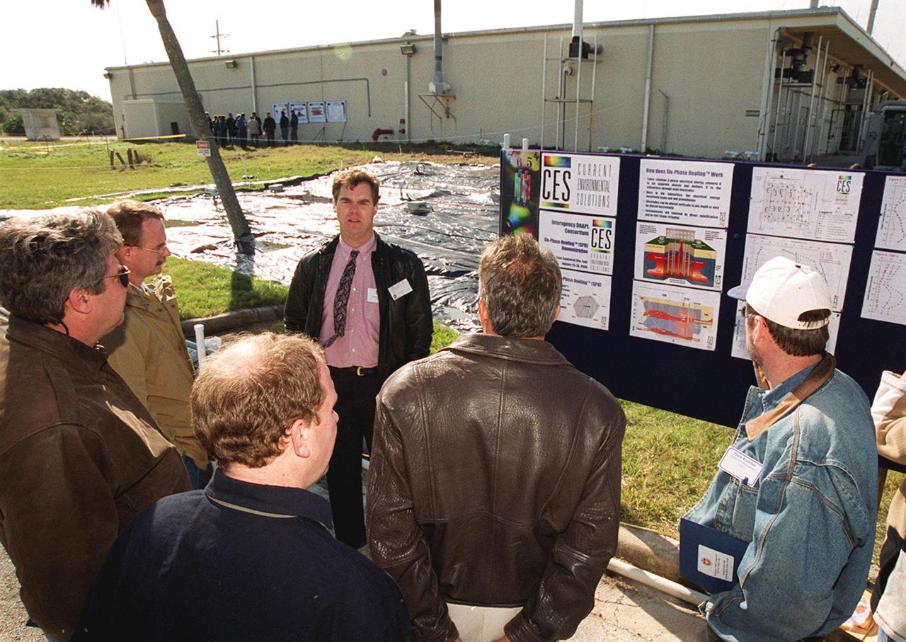 At Launch Complex 34, Greg Beyke, with Current Environmental Solutions, talks to representatives from environmental and federal agencies about the environmental research project that involves the Department of Defense, Environmental Protection Agency, Department of Energy and NASA in a groundwater cleanup effort. Concentrations of trichloroethylene solvent have been identified in the soil at the complex as a result of cleaning methods for rocket parts during the Apollo Program, which used the complex, in the 60s. The group formed the Interagency NDAPL Consortium (IDC) to study three contamination cleanup technologies: Six Phase Soil Heating, Steam Injection and In Situ Oxidation with Potassium Permanganate. All three methods may offer a way to remove the contaminants in months instead of decades. KSC hosted a two-day conference that presented information and demonstrations of the three technologies being tested at the site