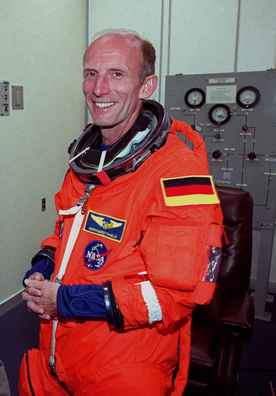 In the Operations and Checkout Building, STS-99 Mission Specialist Gerhard Thiele, who is with the European Space Agency, smiles as he dons his launch and entry suit during final launch preparations. Liftoff of STS-99, known as the Shuttle Radar Topography Mission (SRTM), is scheduled for 12:47 p.m. EST from Launch Pad 39A. The SRTM will chart a new course to produce unrivaled 3-D images of the Earth's surface, using two antennae and a 200-foot-long section of space station-derived mast protruding from the payload bay. The result of the Shuttle Radar Topography Mission could be close to 1 trillion measurements of the Earth's topography. Besides contributing to the production of better maps, these measurements could lead to improved water drainage modeling, more realistic flight simulators, better locations for cell phone towers, and enhanced navigation safety. The mission is expected to last about 11days. Endeavour is expected to land at KSC Friday, Feb. 11, at 4:55 p.m. EST