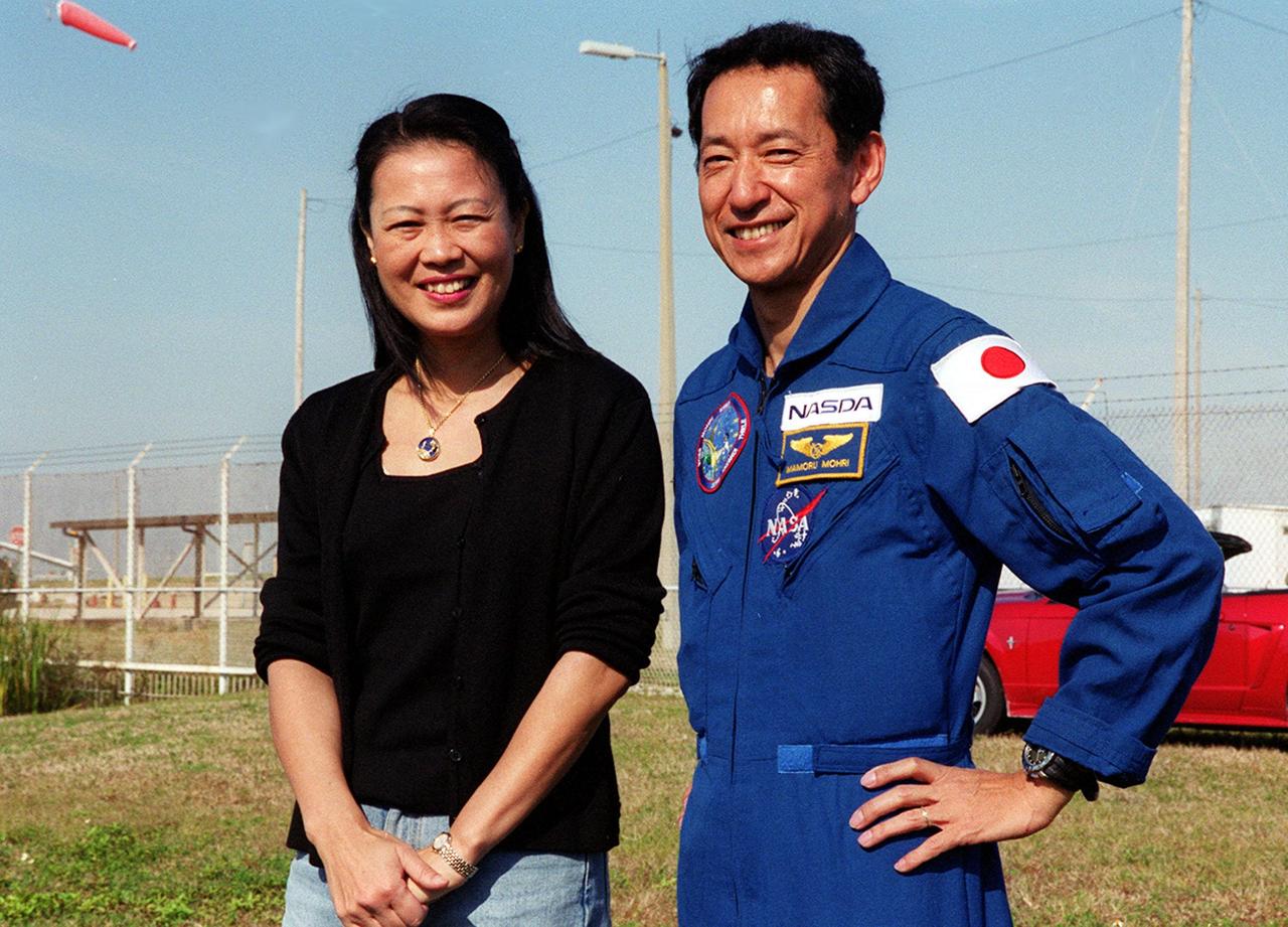 KENNEDY SPACE CENTER, Fla. -- The day before the expected launch of STS-99, Mission Specialist Mamoru Mohri (right) enjoys a reunion with his wife, Akiko, near Launch Pad 39A. STS-99, known as the Shuttle Radar Topography Mission (SRTM), is scheduled to lift off 12:47 p.m. EST from Launch Pad 39A. The SRTM will chart a new course to produce unrivaled 3-D images of the Earth's surface, using two antennae and a 200-foot-long section of space station-derived mast protruding from the payload bay. The result of the Shuttle Radar Topography Mission could be close to 1 trillion measurements of the Earth's topography. Besides contributing to the production of better maps, these measurements could lead to improved water drainage modeling, more realistic flight simulators, better locations for cell phone towers, and enhanced navigation safety. The mission is expected to last about 11days, with Endeavour landing at KSC Friday, Feb. 11, at 4:55 p.m