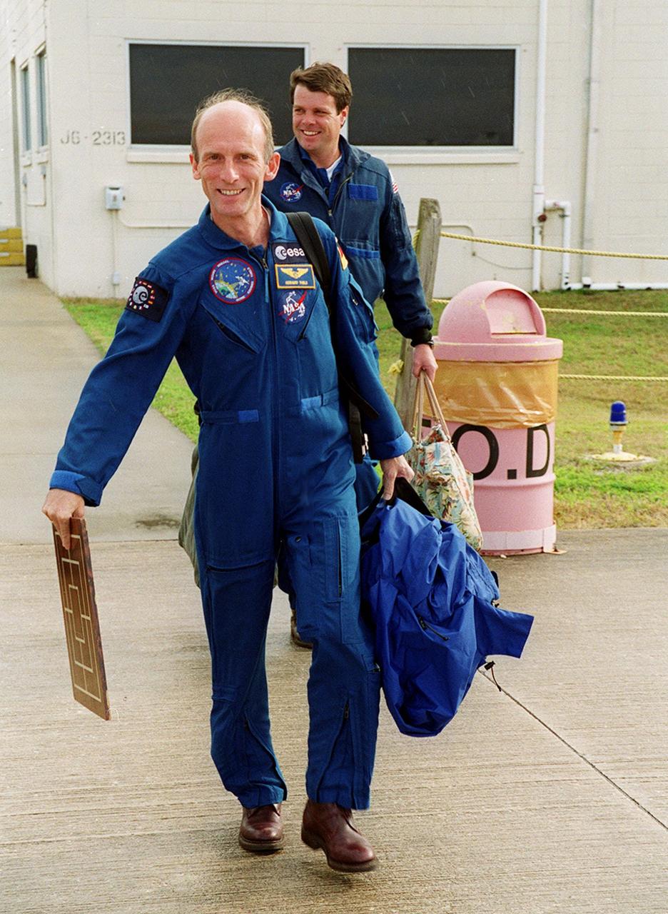 STS-99 Mission Specialist Gerhard Thiele (foreground) and Commander Kevin Kregel make their way to the runway at the Shuttle Landing Facility for a return flight to Houston. During the Jan. 31 launch countdown, Endeavour's enhanced master events controller (E-MEC) No. 2 failed a standard preflight test. Launch was postponed and Shuttle managers decided to replace the E-MEC located in the orbiter's aft compartment. Launch controllers will be in a position to begin the STS-99 countdown the morning of Feb. 6 and ready to support a launch midto late next week pending availability of the Eastern Range. The postponed launch gives the crew an opportunity for more training and time with their families. Known as the Shuttle Radar Topography Mission, it will chart a new course to produce unrivaled 3-D images of the Earth's surface, using two antennae and a 200-foot-long section of space station-derived mast protruding from the payload bay. The result could be close to 1 trillion measurements of the Earth's topography. Besides contributing to the production of better maps, these measurements could lead to improved water drainage modeling, more realistic flight simulators, better locations for cell phone towers, and enhanced navigation safety