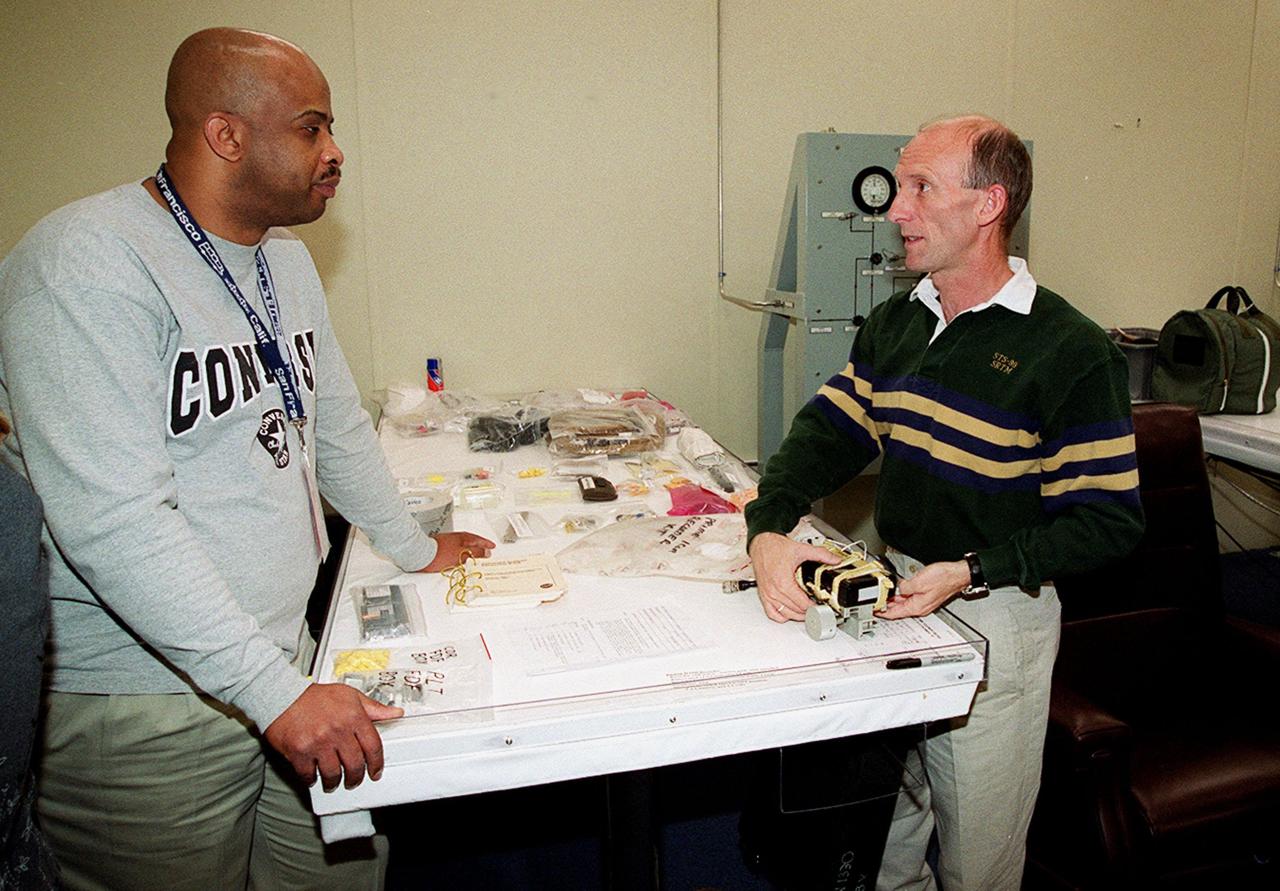 In the Operations and Checkout Building's suitup room, Andre Denard, with United Space Alliance, helps STS-99 Mission Specialist Gerhard Thiele with pre-pack and fit check. Thiele and other crew members Commander Kevin Kregel, Pilot Dominic Gorie, and Mission Specialists Janet Kavandi, Janice Voss, and Mamoru Mohri of Japan are preparing for launch of their mission on Feb. 11 at 12:30 p.m. EST aboard Space Shuttle Endeavour. STS-99 is the Shuttle Radar Topography Mission, which will produce unrivaled 3-D images of the Earth's surface. The result of the Shuttle Radar Topography Mission could be close to 1 trillion measurements of the Earth's topography. Landing is expected at KSC on Feb. 22 at 4:36 p.m. EST