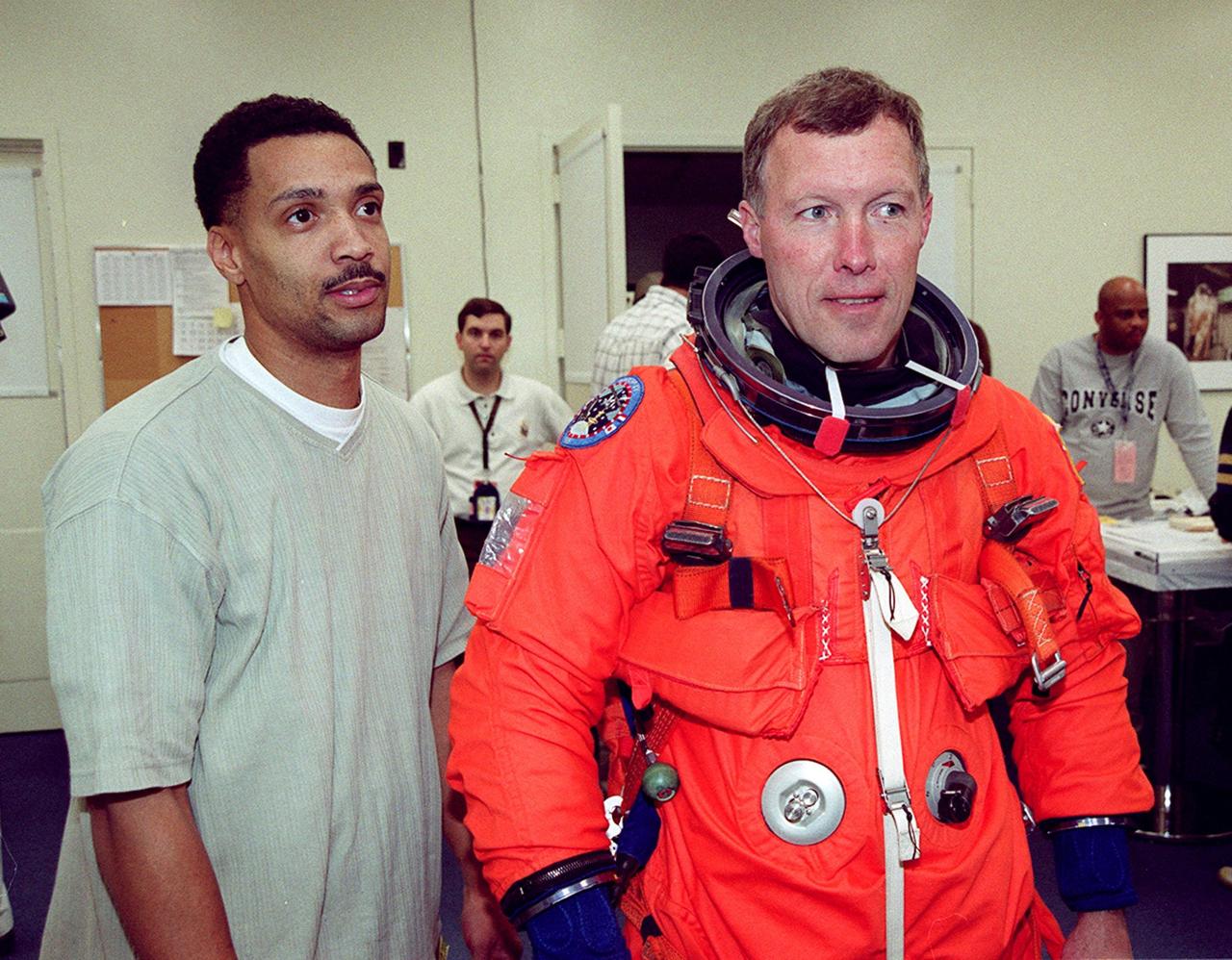 In the Operations and Checkout Building's suitup room, Carlous Gillis, with United Space Alliance, helps STS-99 Pilot Dominic Gorie with pre-pack and fit check. Gorie and other crew members Commander Kevin Kregel, and Mission Specialists Janet Kavandi, Janice Voss, Gerhard Thiele of Germany and Mamoru Mohri of Japan are preparing for launch of their mission on Feb. 11 at 12:30 p.m. EST aboard Space Shuttle Endeavour. STS-99 is the Shuttle Radar Topography Mission, which will produce unrivaled 3-D images of the Earth's surface. The result of the Shuttle Radar Topography Mission could be close to 1 trillion measurements of the Earth's topography. Landing is expected at KSC on Feb. 22 at 4:36 p.m. EST
